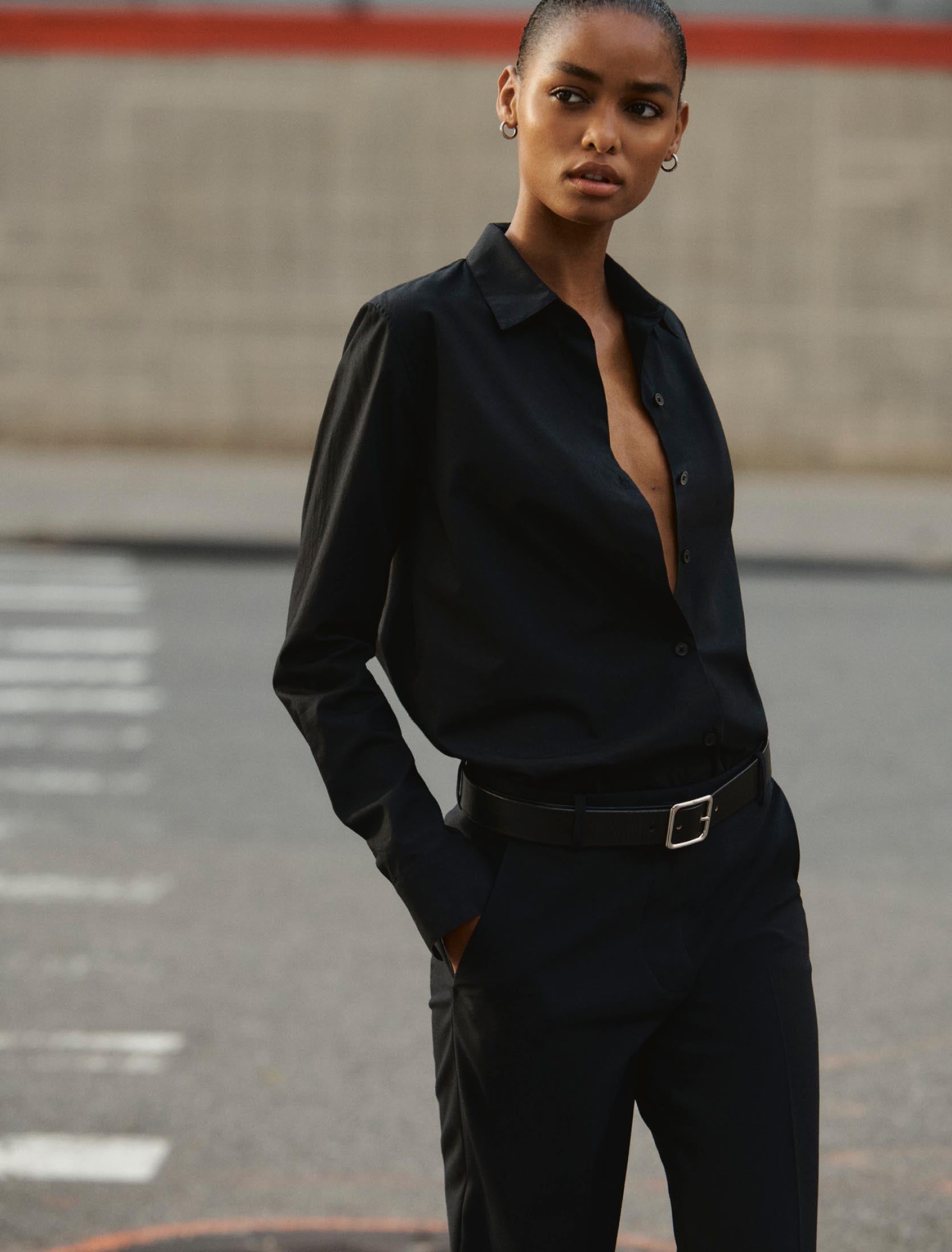 Woman wearing a black button down poplin shirt