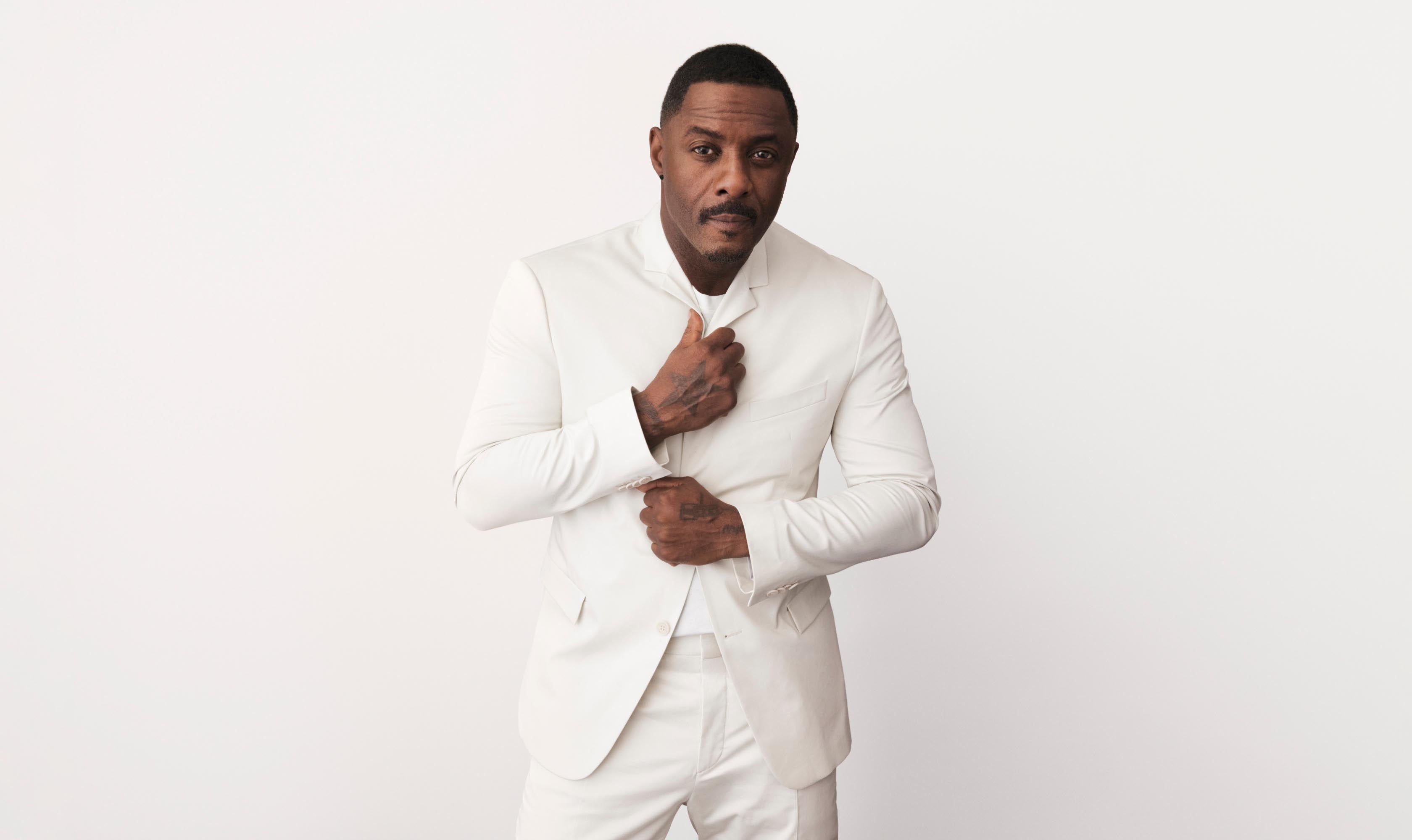 Idris Elba wearing a white linen suit