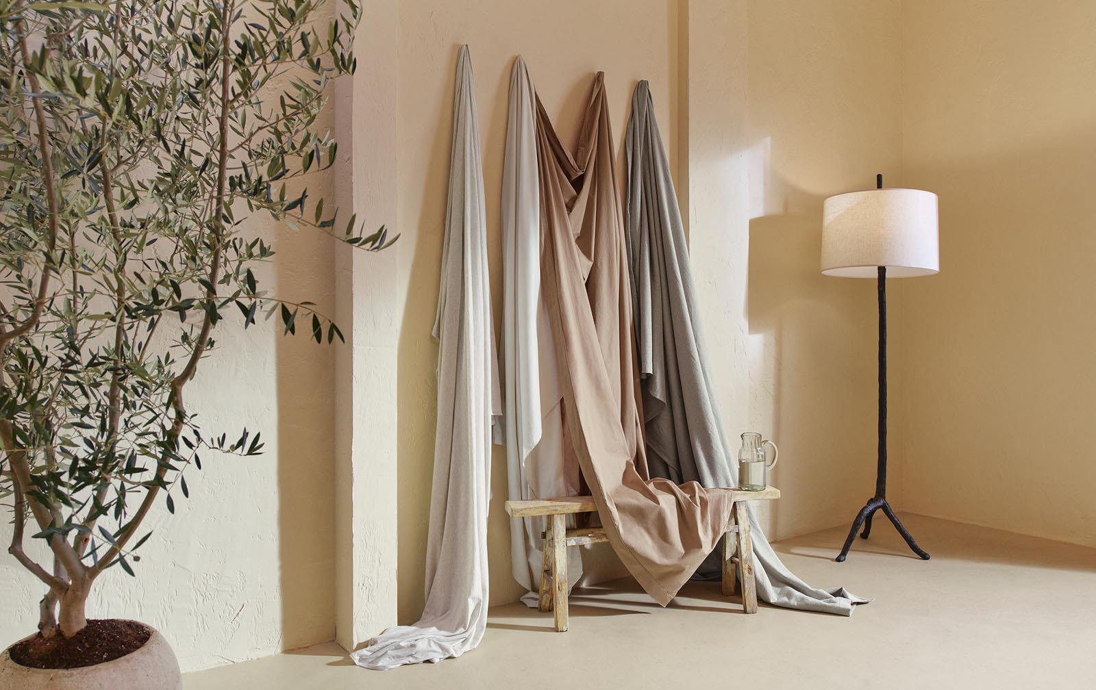 A modern minimalist bathroom featuring towels, bath rugs.