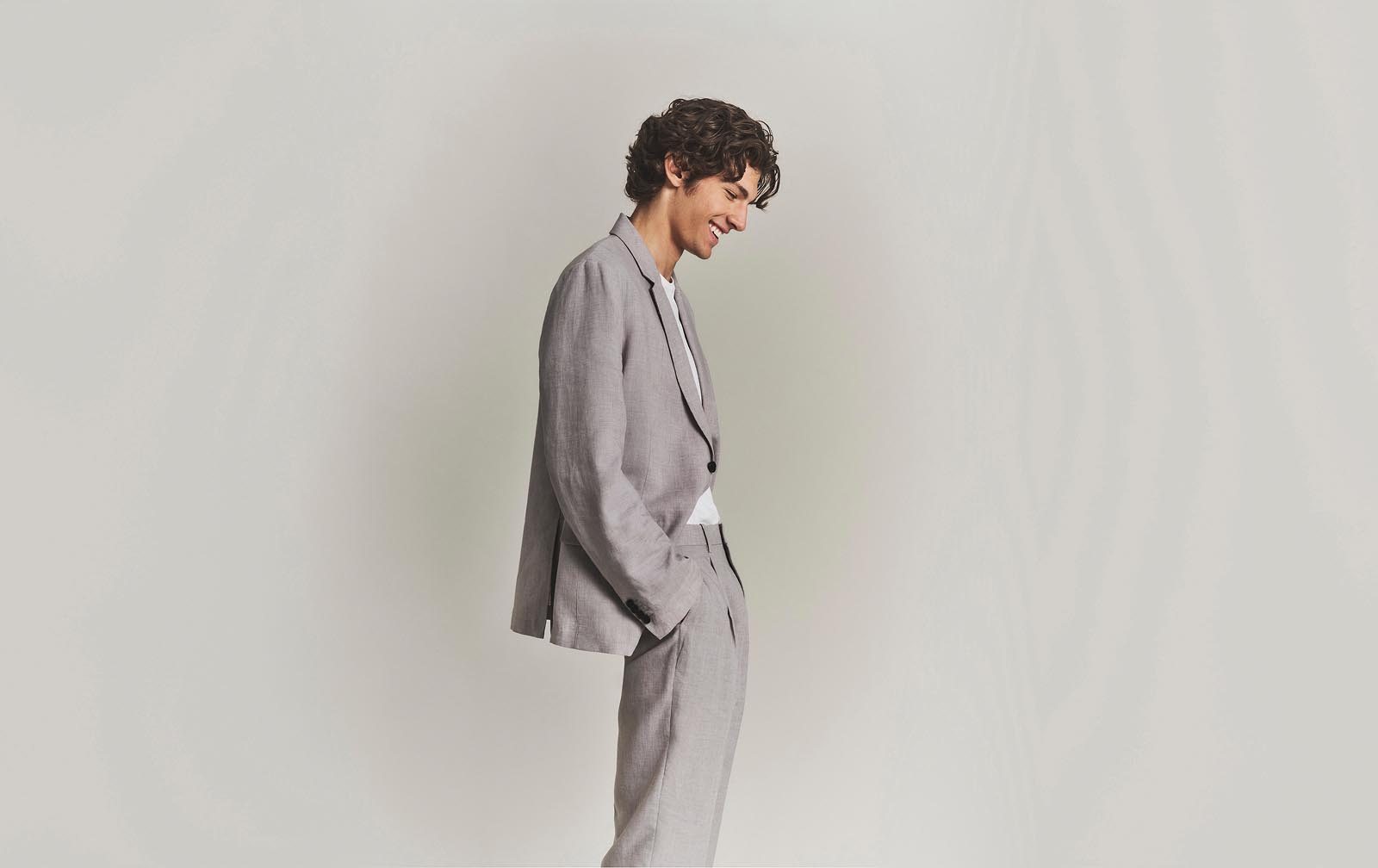 Model posing in a matching grey suit.