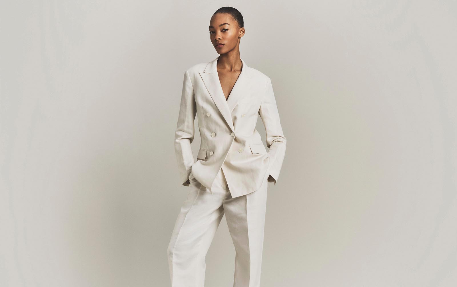 Model posing in a matching linen suit set.