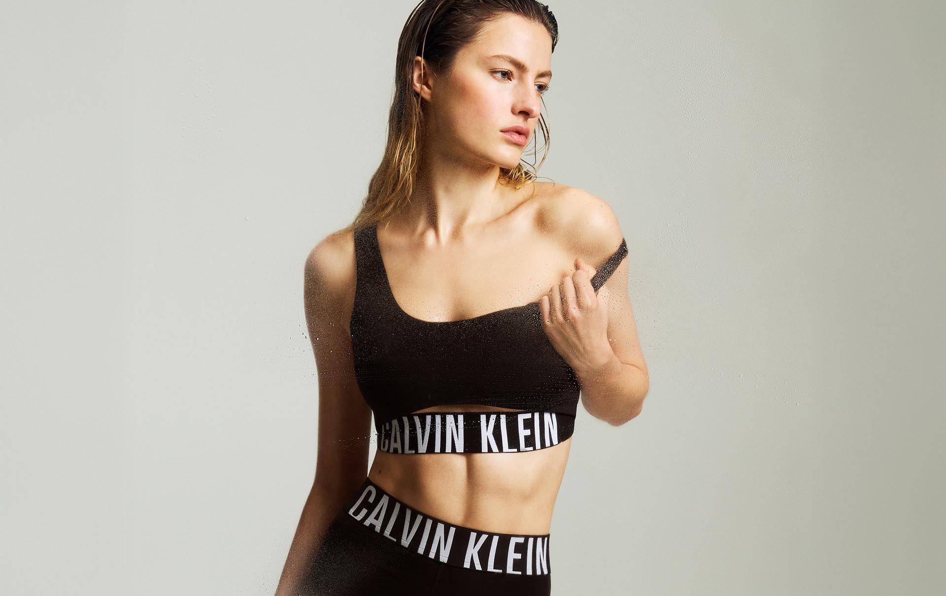 Model posing in a matching sports bra and leggings set.