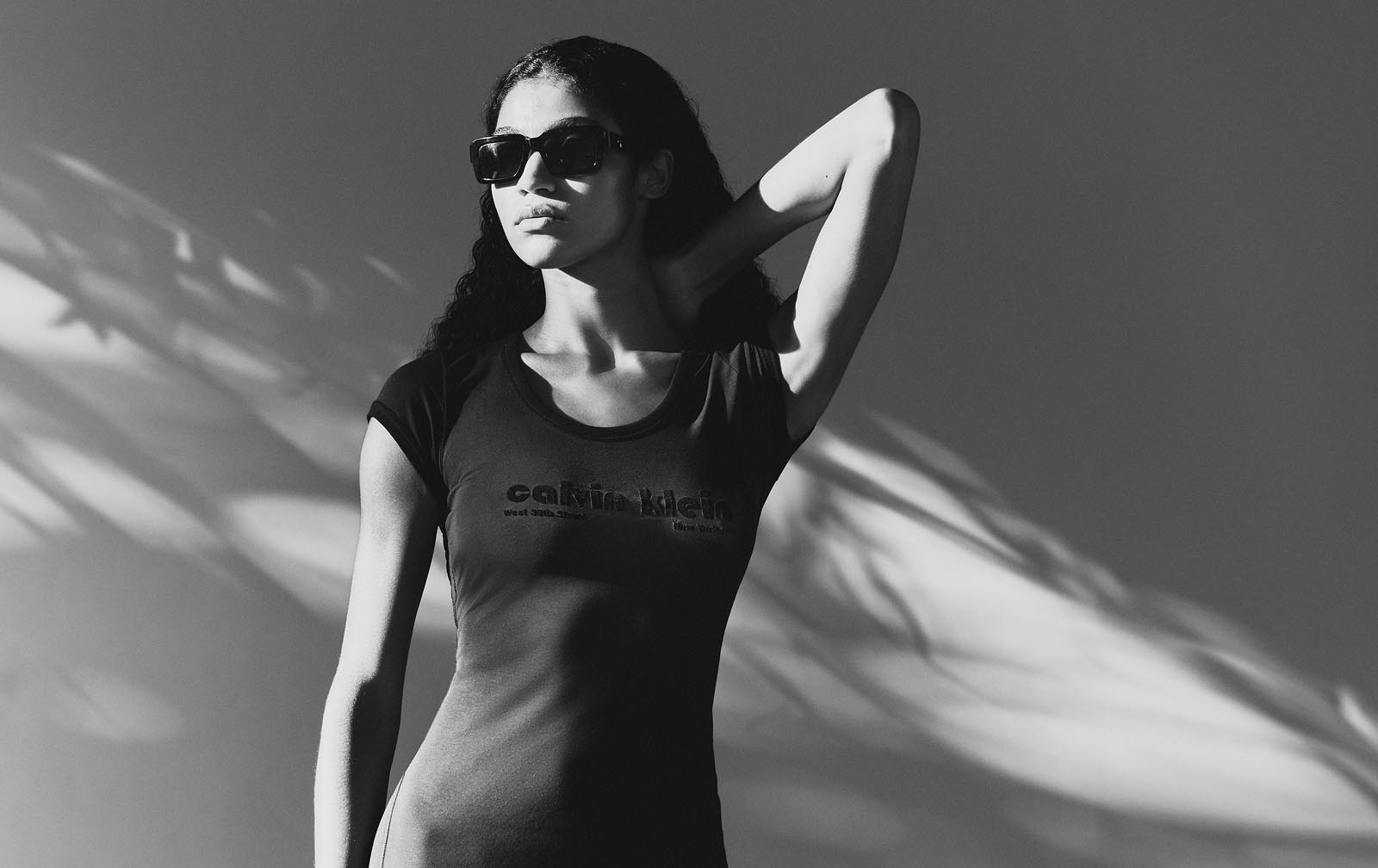 Model wearing a black Calvin Klein dress.
