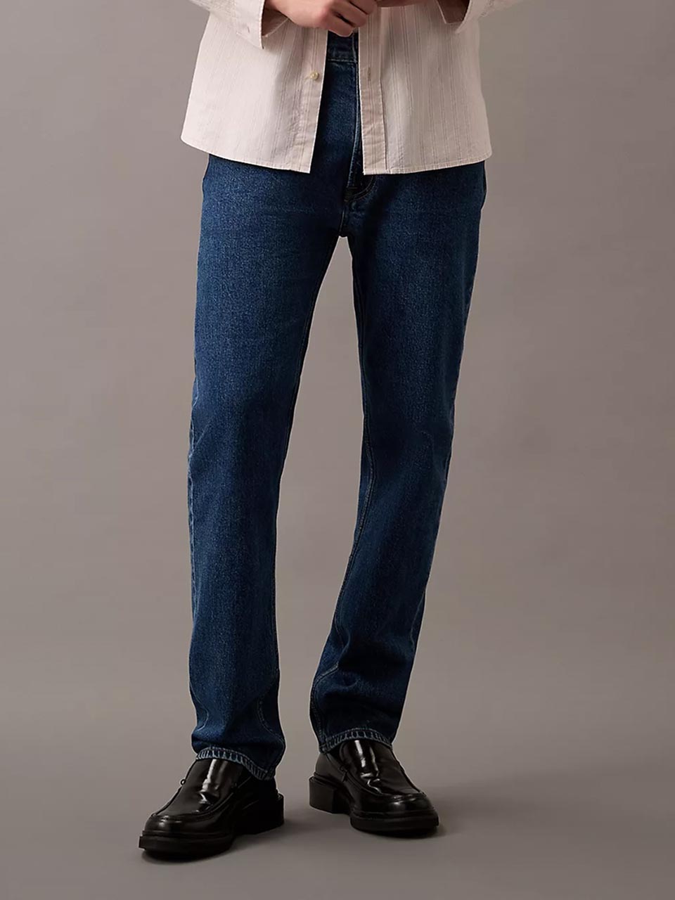 Model wearing head to toe Calvin Klein featuring the high rise flare jeans.