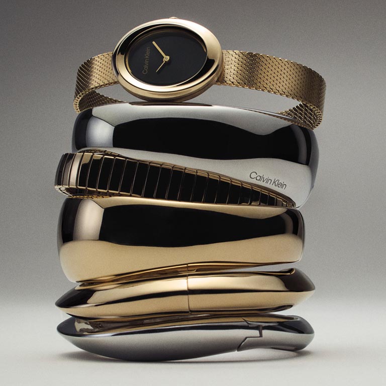 Still life image of a stack of watches and bracelets