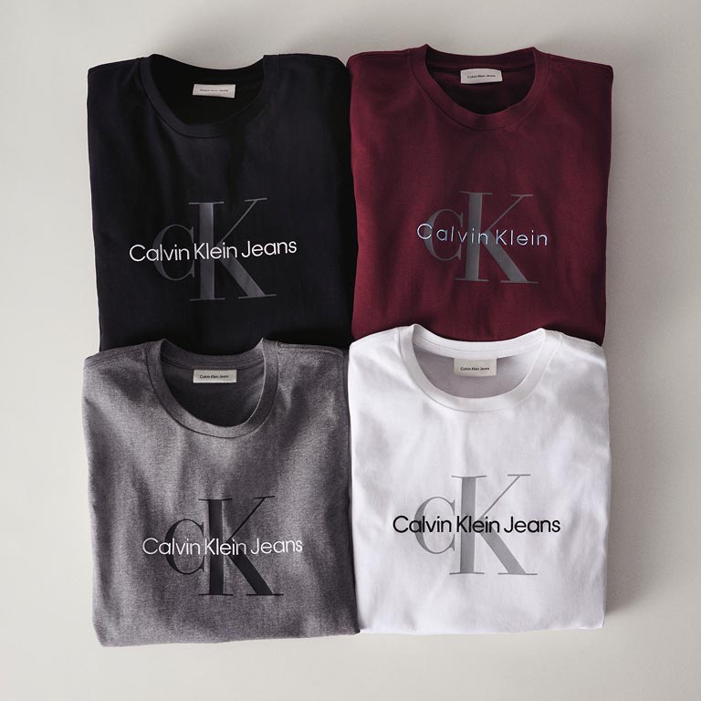 Still life image of a stack of CK logo t-shirts