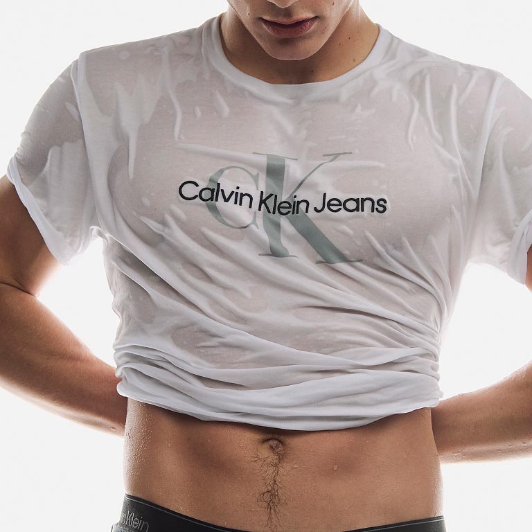 Model posing in a white CK logo t-shirt