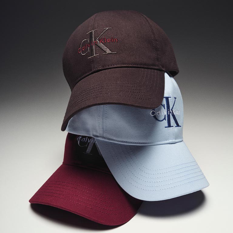 Still life image of a stack of baseball caps