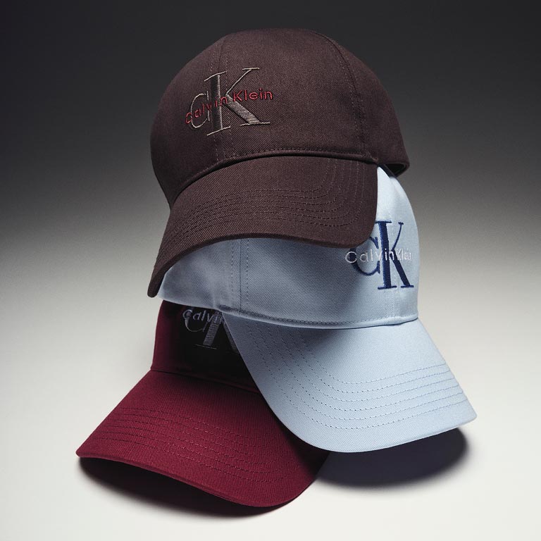 Still life image of a stack of baseball caps