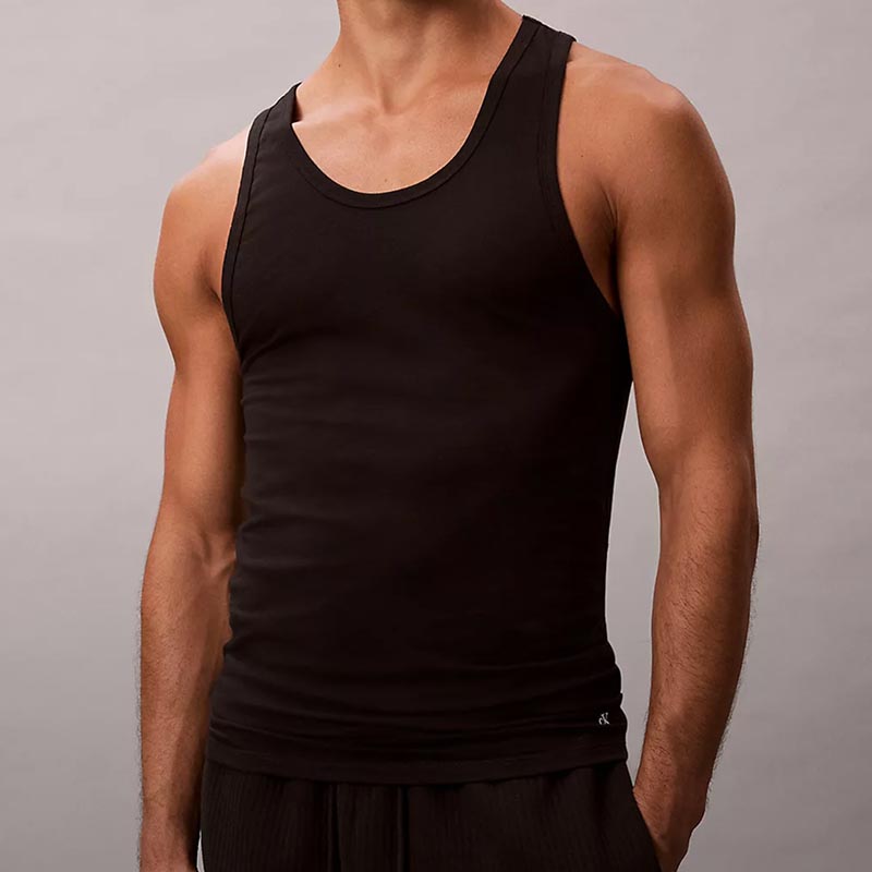 Model posing in a black undershirt