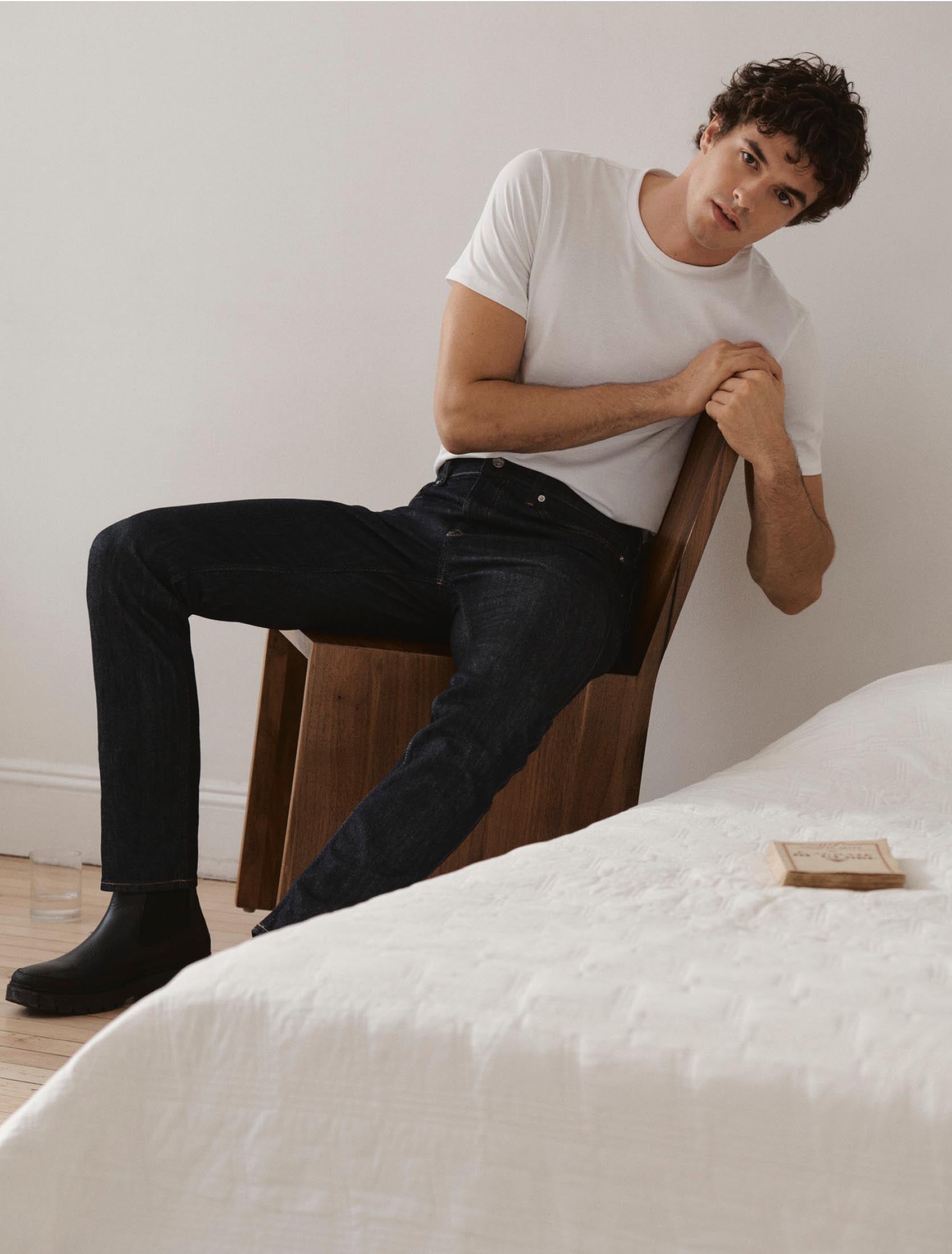 Man posing wearing dark denim jeans