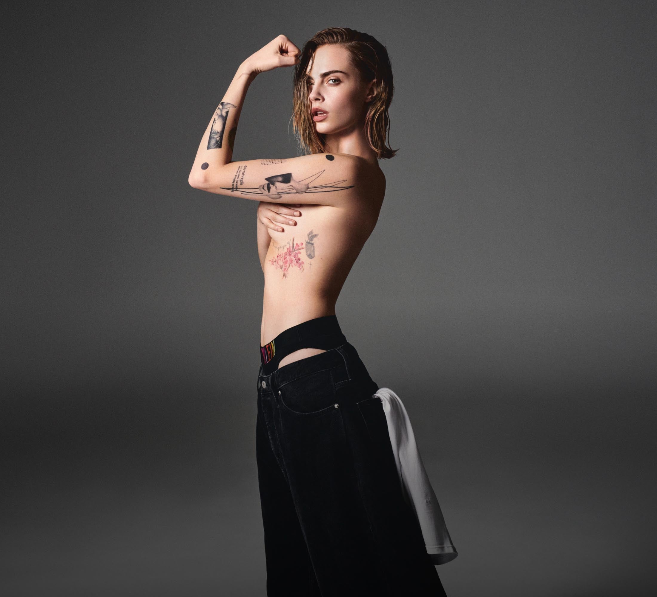 Cara Delevingne posing topless wearing Calvin Klein Pride underwear