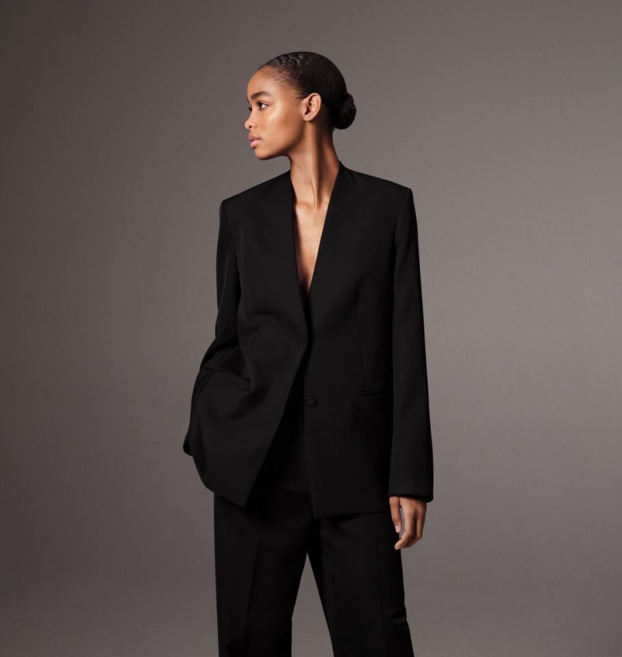 Model posing in a black tailored blazer