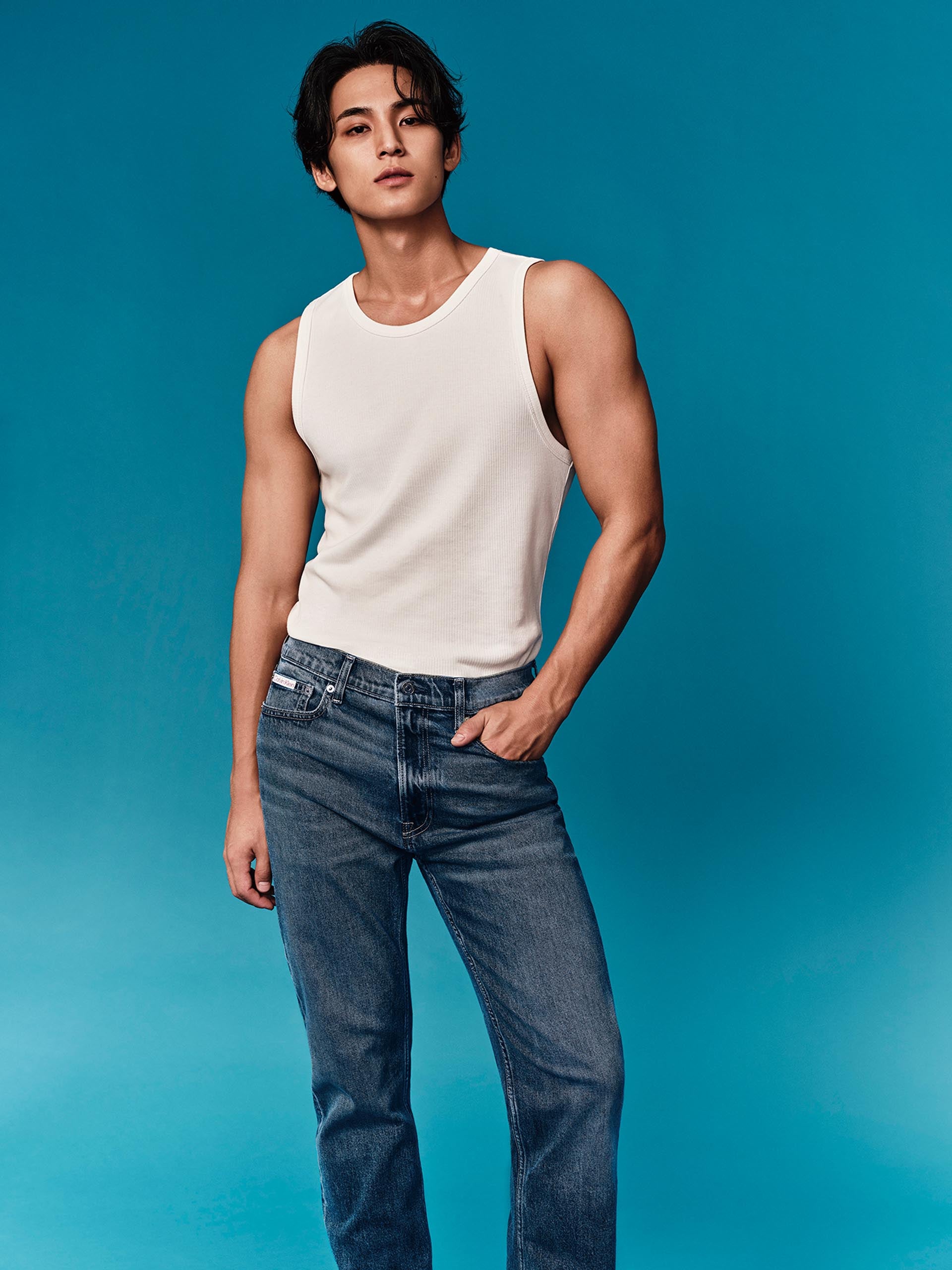 Mingyu wearing a tank top and jeans