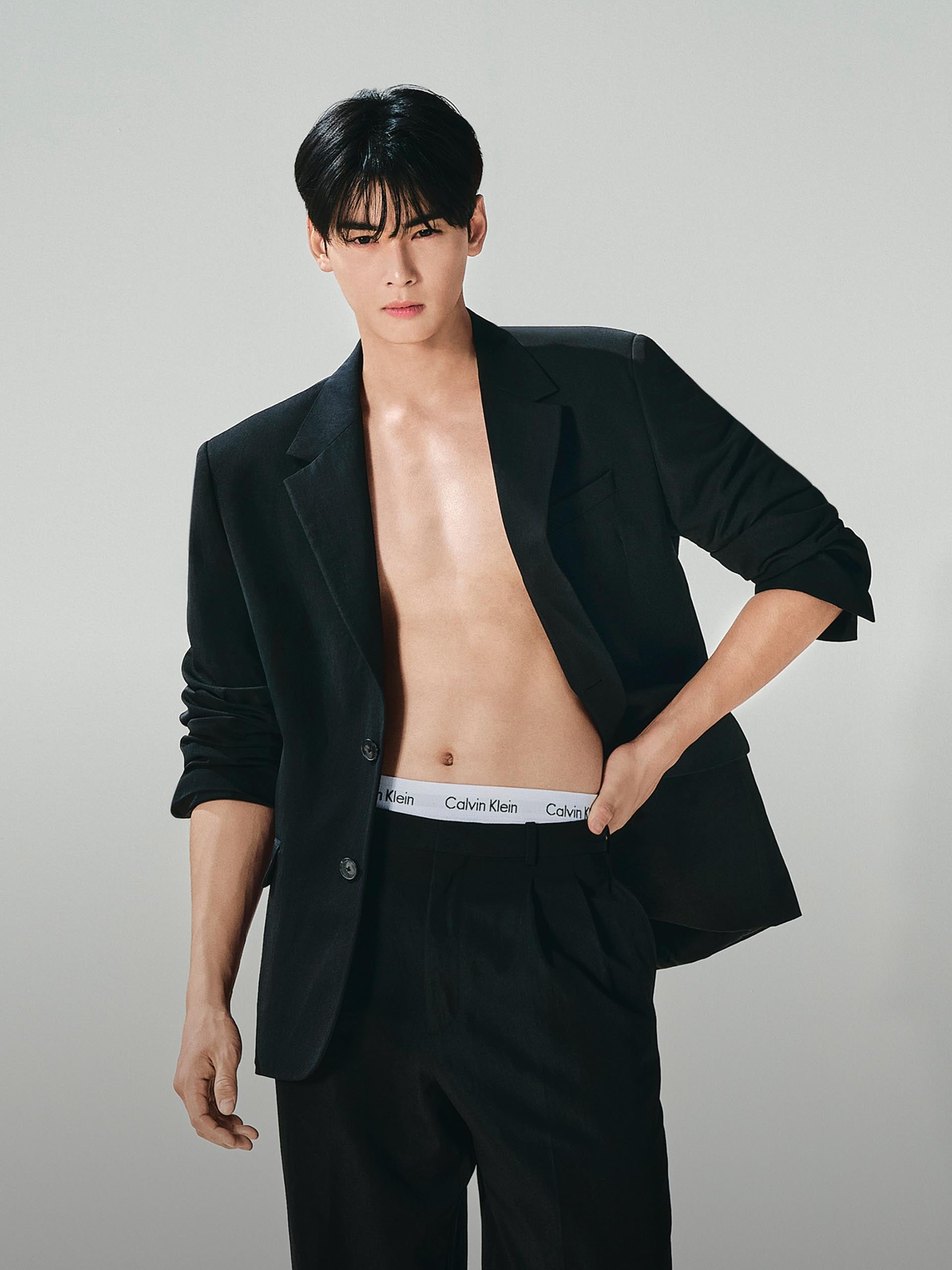 Mingyu wearing a tank top and jeans