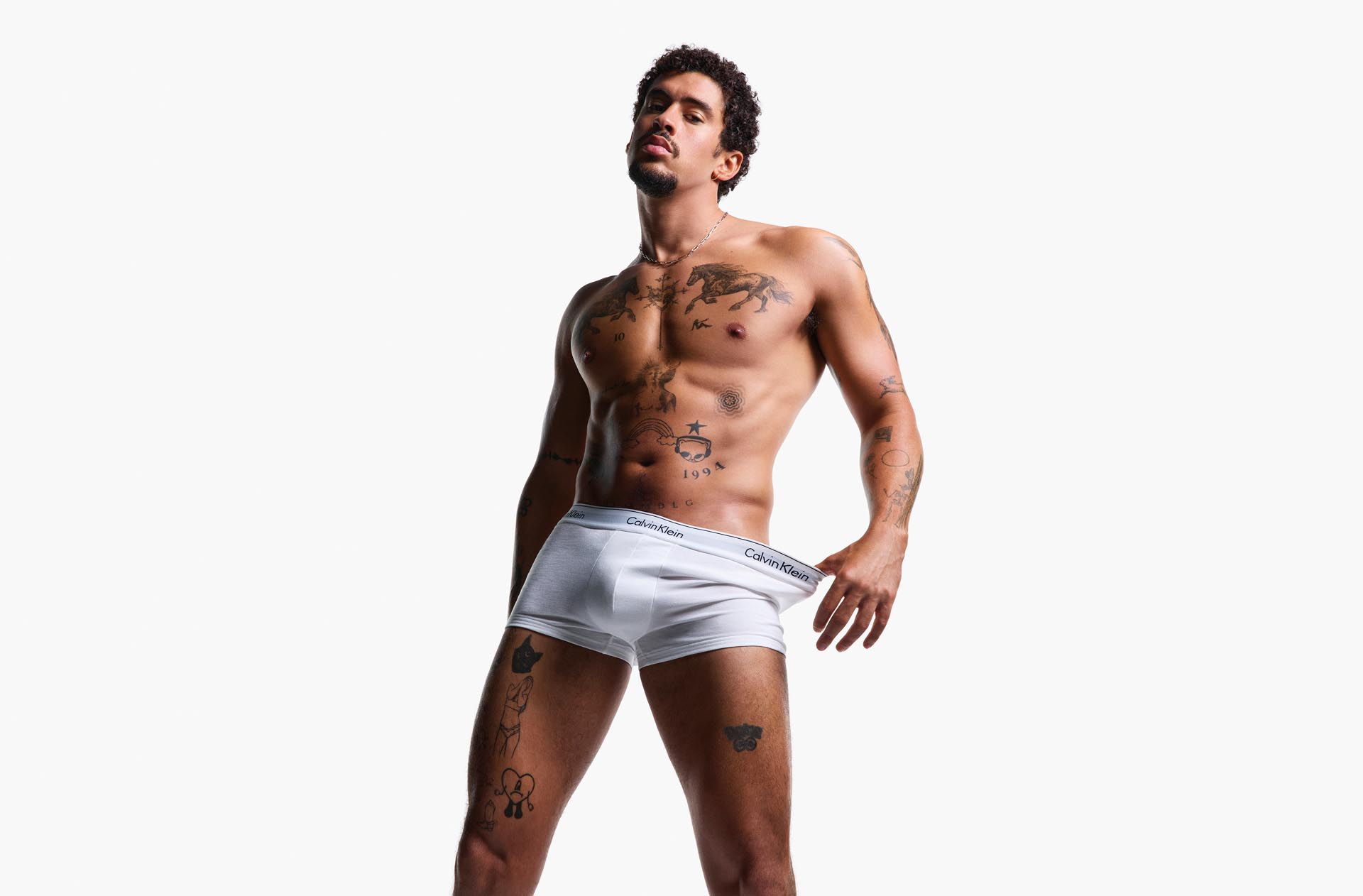 Bad Bunny posing in Calvin Klein Underwear