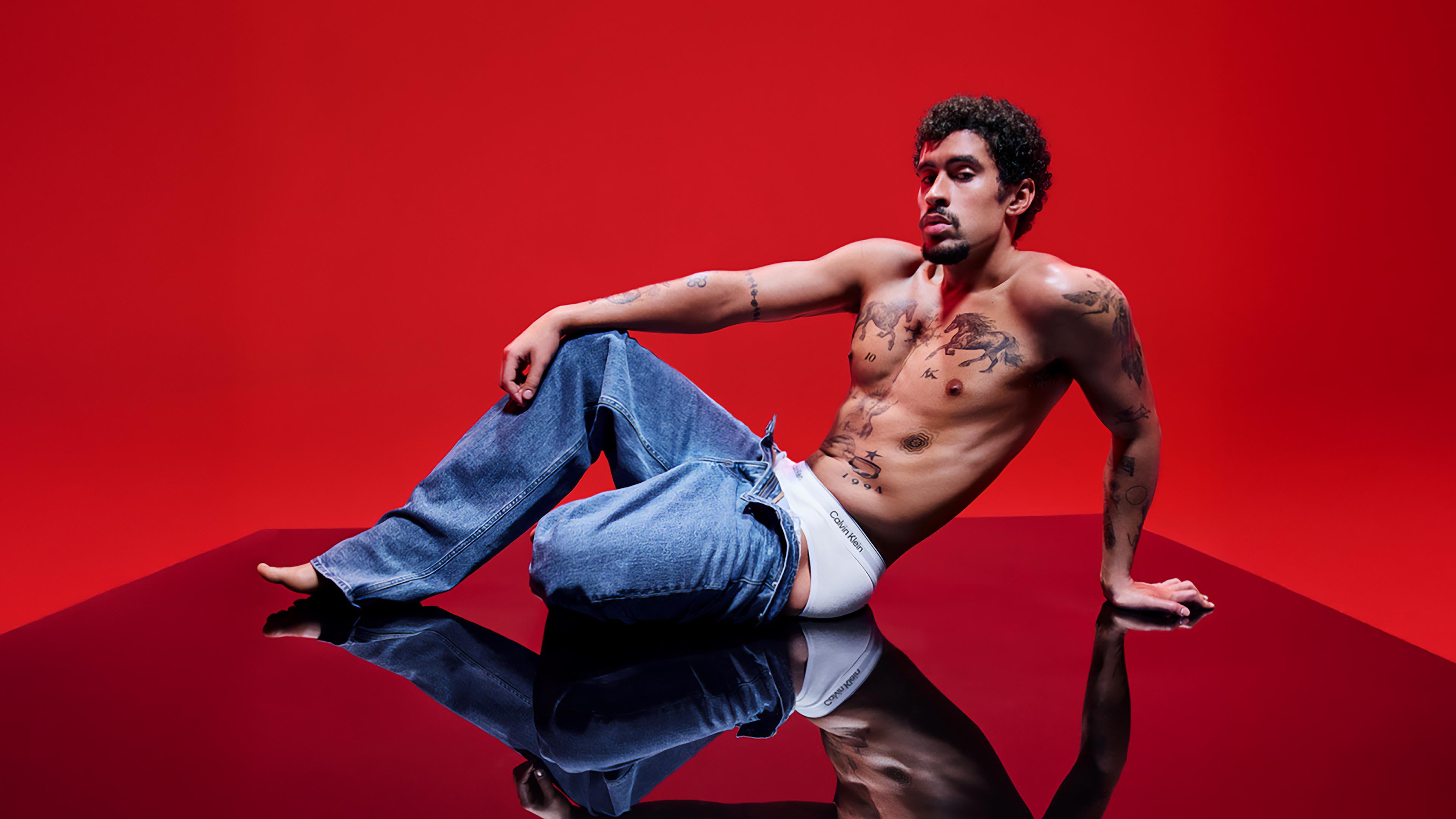 Bad Bunny wearing Calvin Klein denim and underwear.