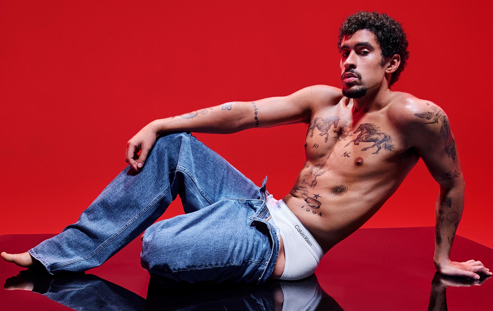 Bad Bunny wearing Calvin Klein denim and underwear.