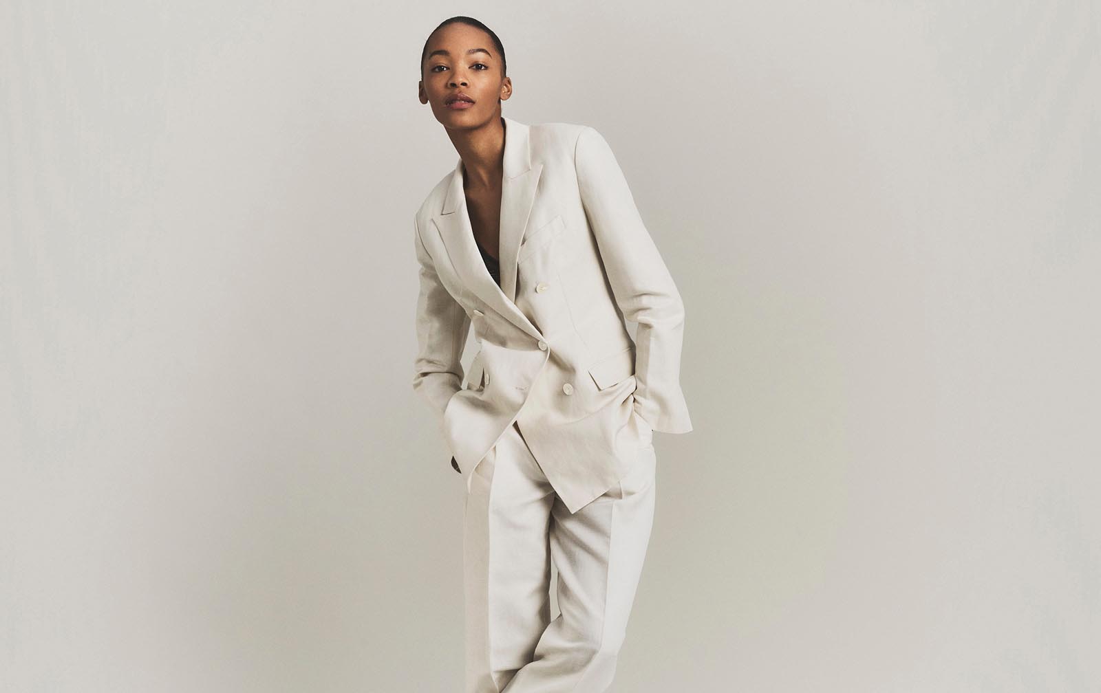 Model posing in a matching linen suit set.