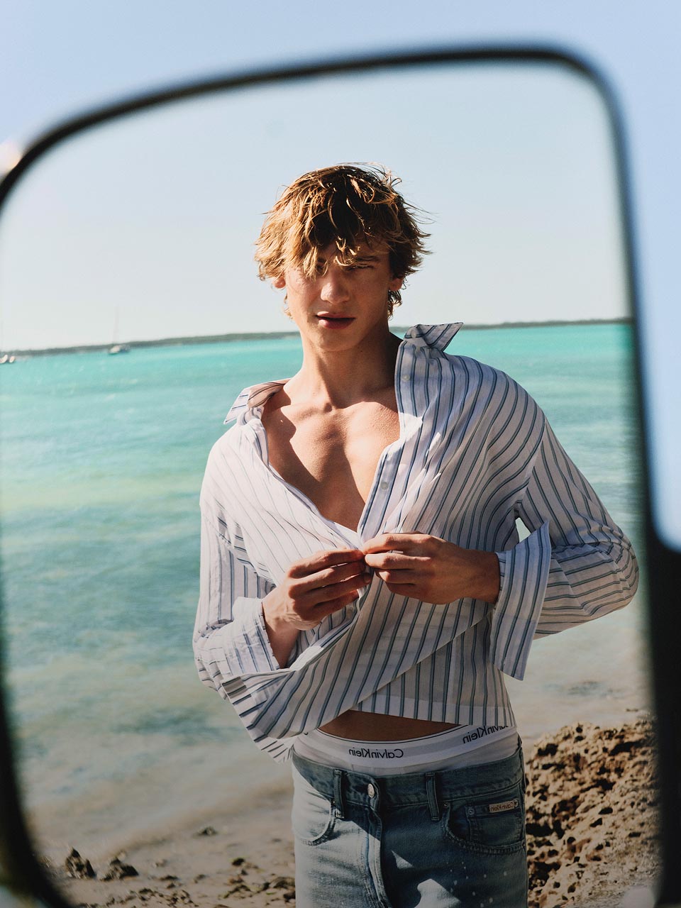 Model posing in a lightweight shirt and shorts set.