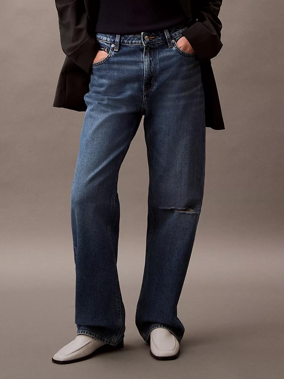 Model wearing head to toe Calvin Klein featuring the 90s straight jeans.