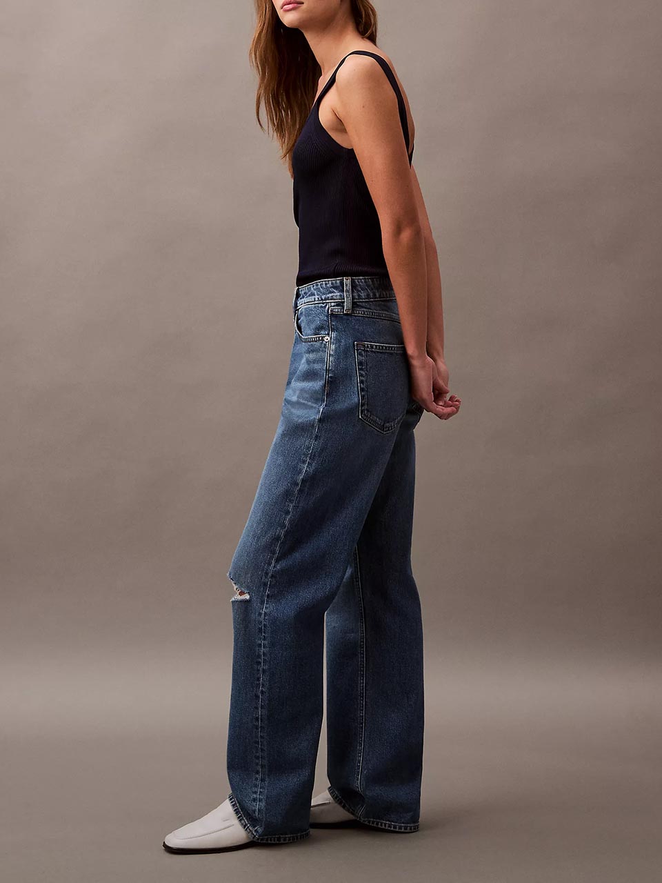 Model wearing head to toe Calvin Klein featuring the 90s straight jeans.