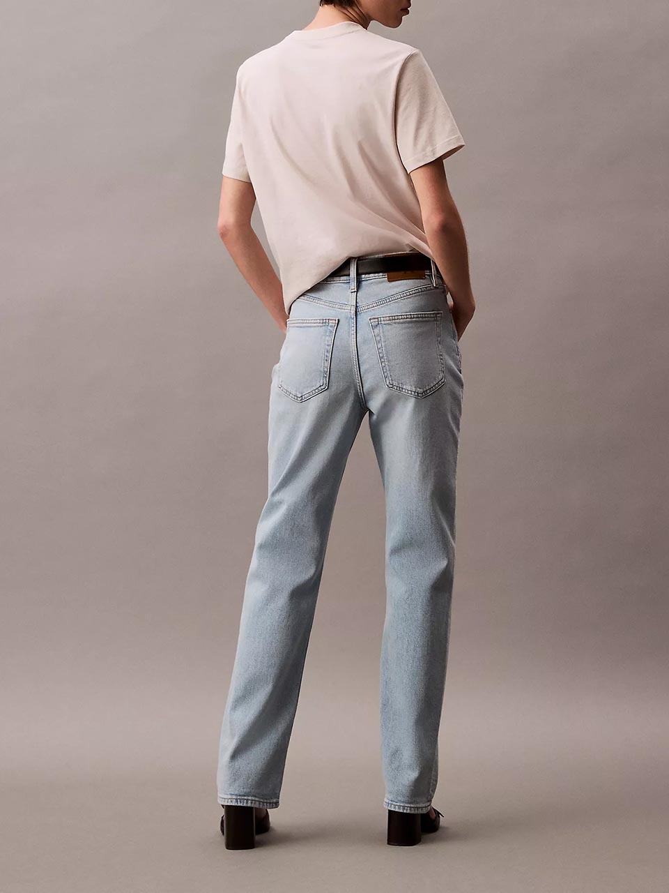 Model wearing head to toe black outfit featuring the high rise straight fit jeans.