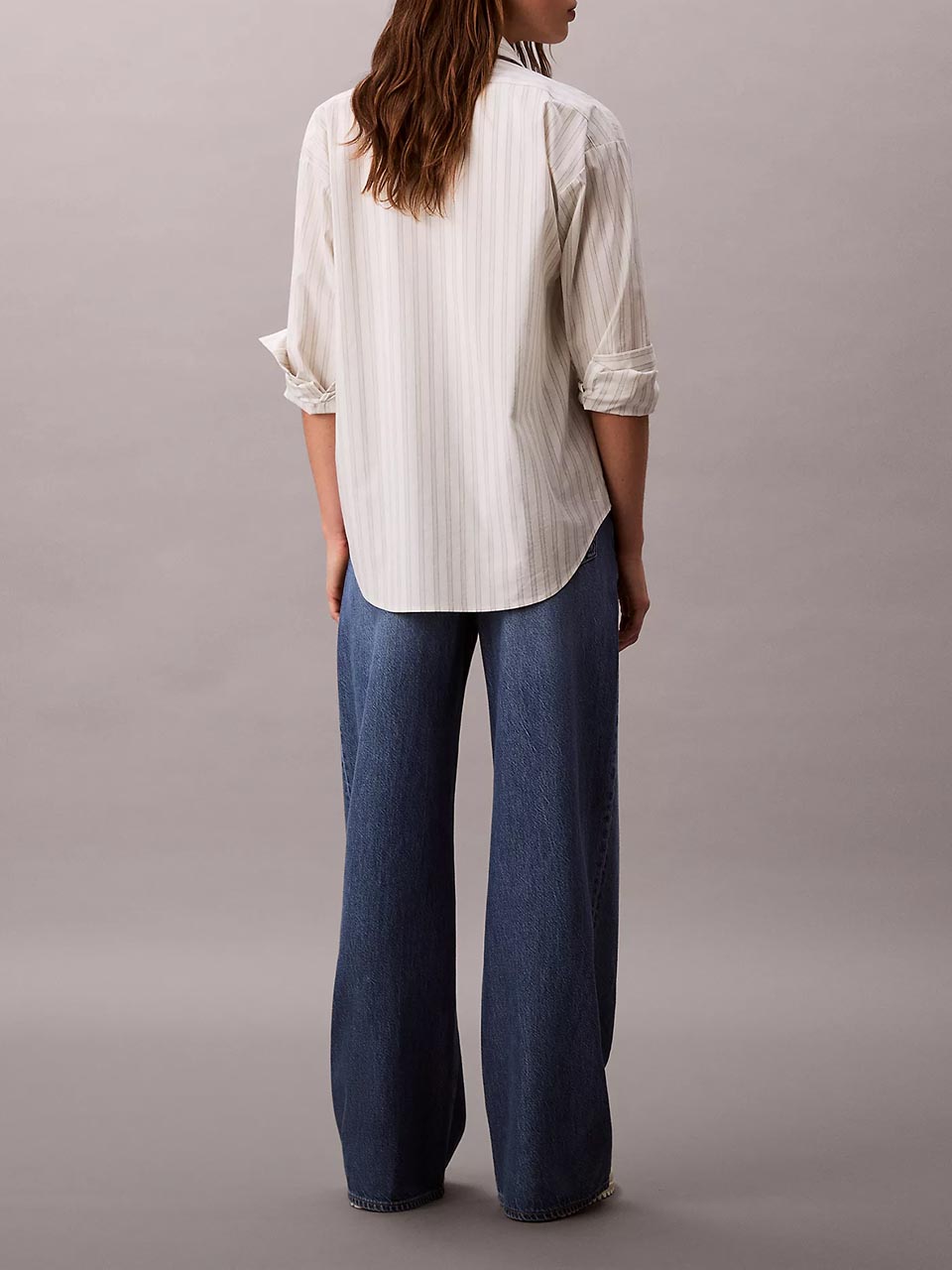 Model wearing head to toe Calvin Klein featuring the ultra high rise wide leg jeans.