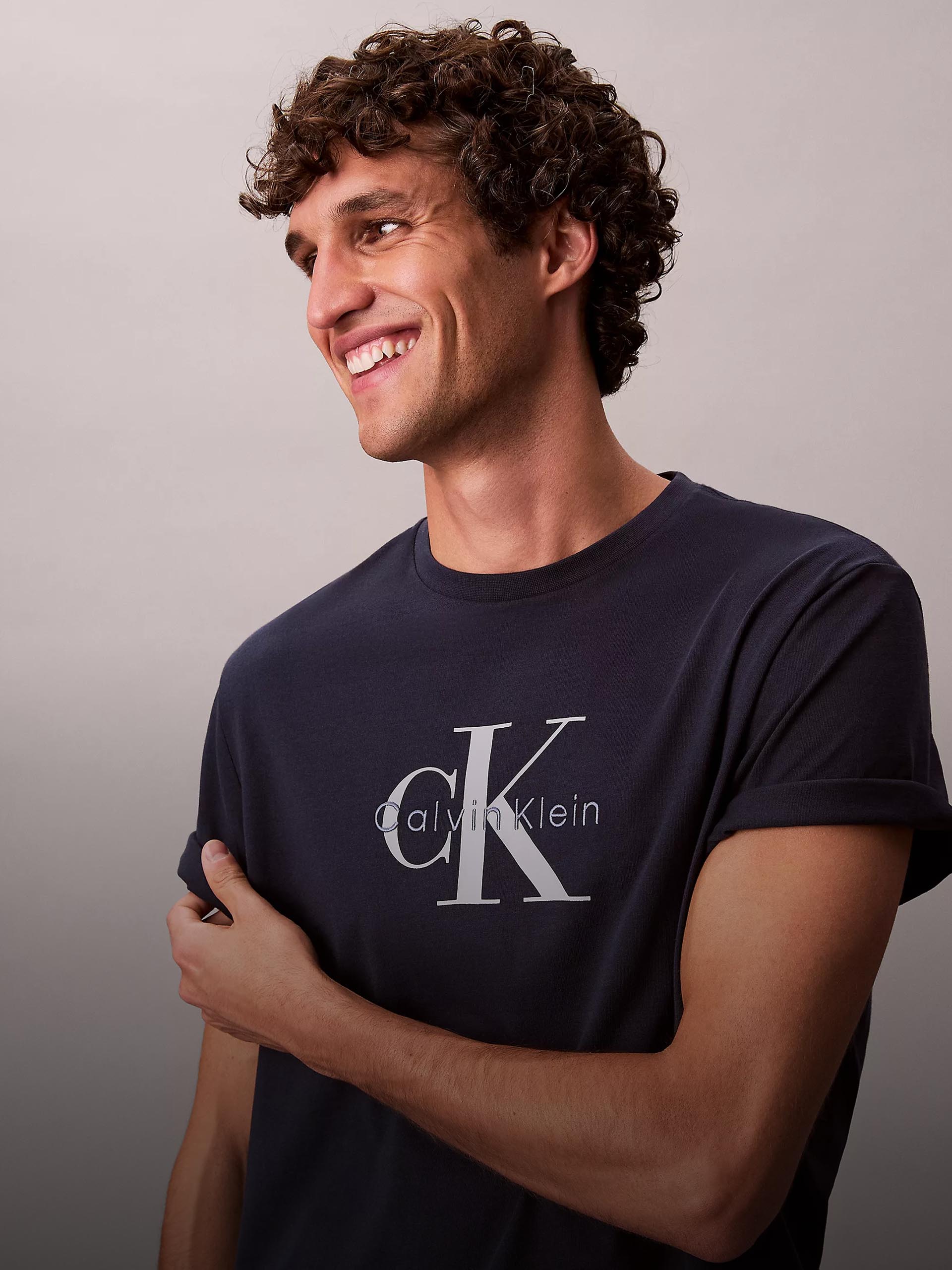Model wearing a classic navy blue t-shirt with iconic CK Calvin Klein logo.