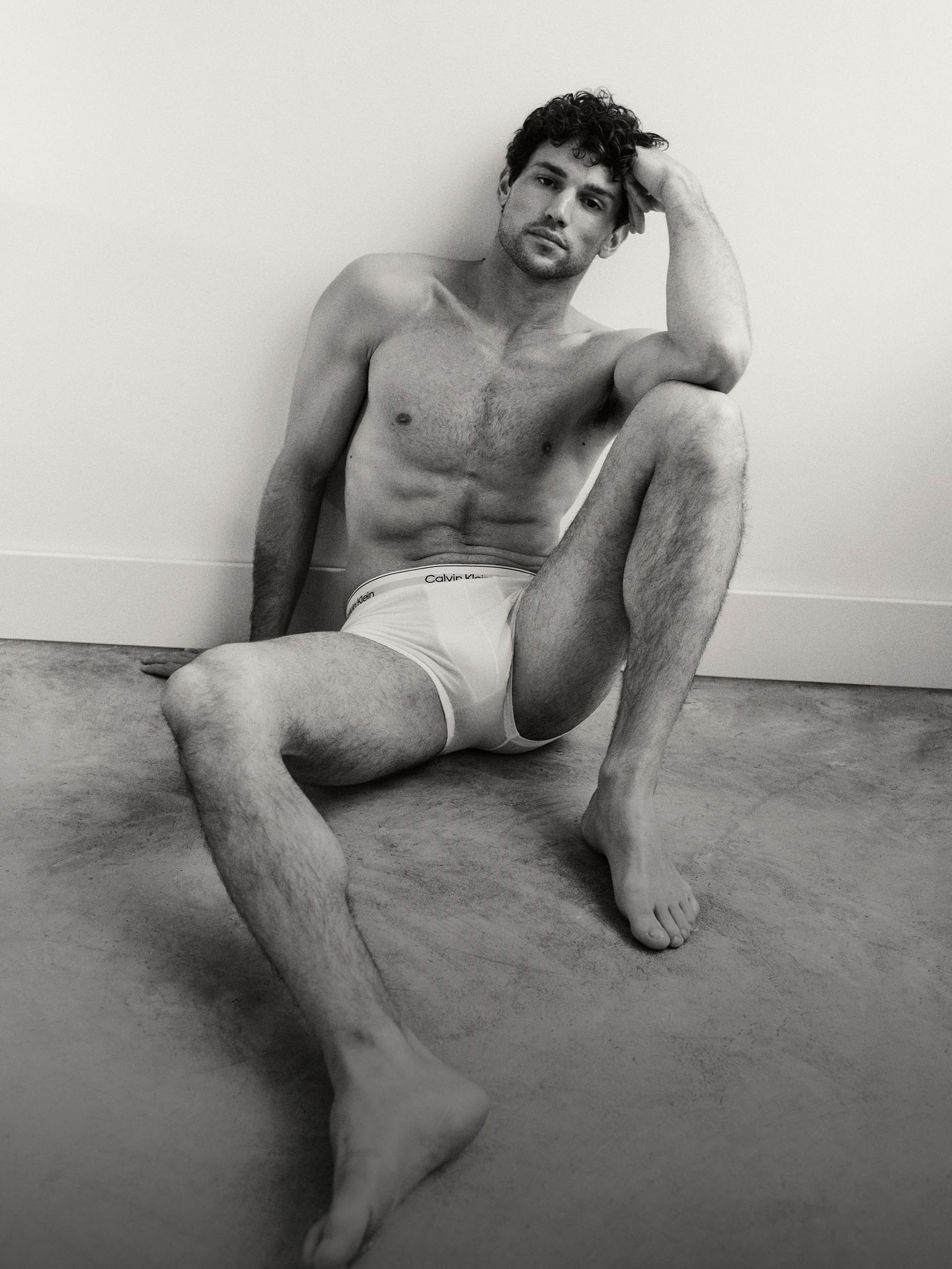 Model wearing a white cotton boxer brief with Calvin Klein logo.