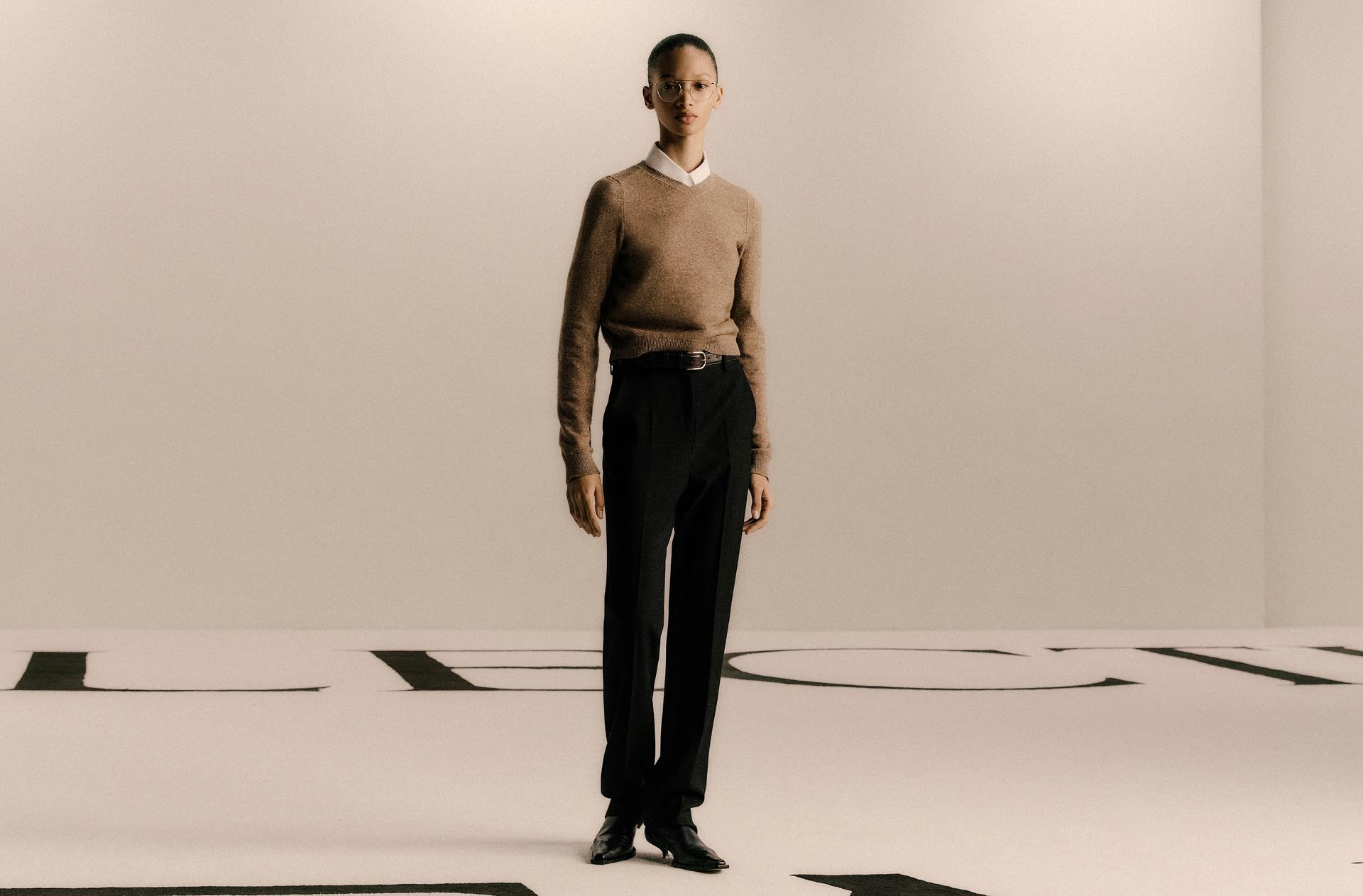 Model wearing Calvin Klein sweater and trousers.
