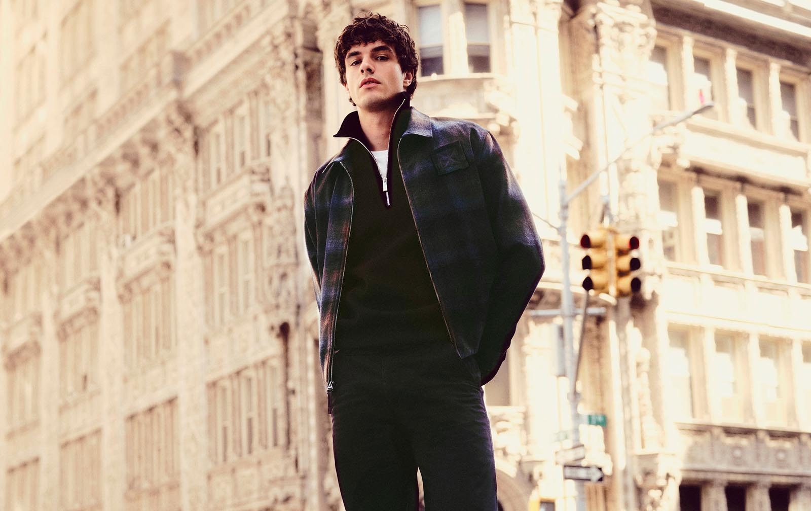 Model posing in a city wearing Calvin Klein fall apparel