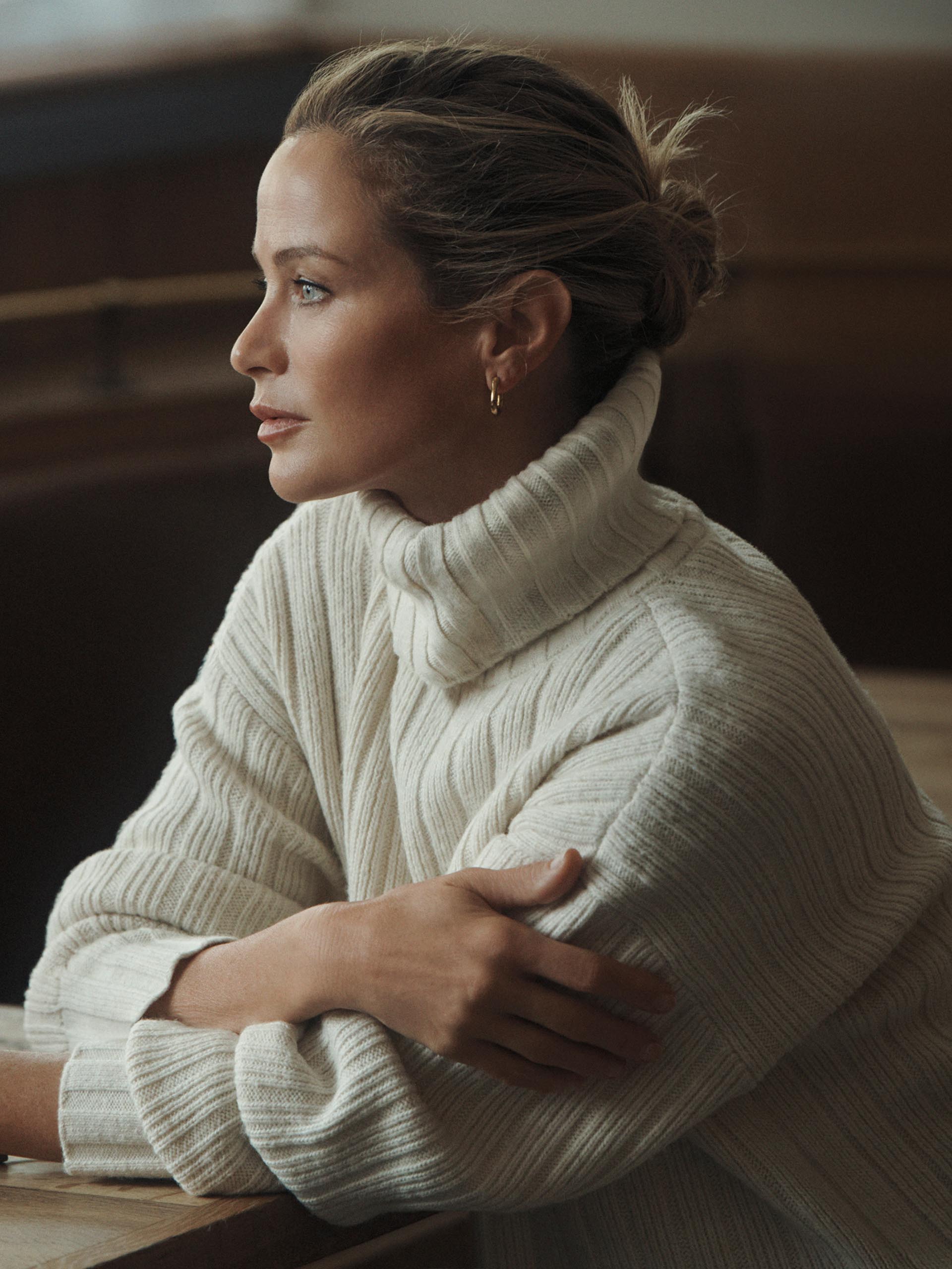 Models posing in white turtleneck sweaters