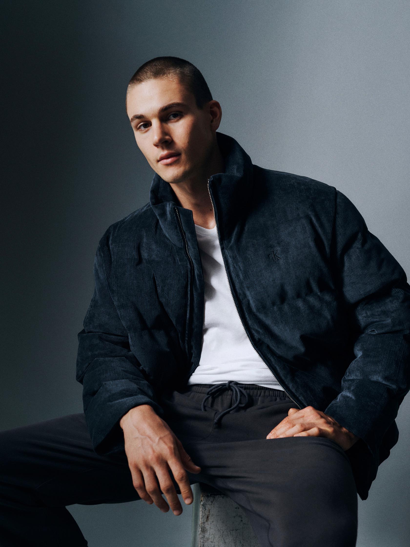 Models posing in Calvin Klein puffer coats