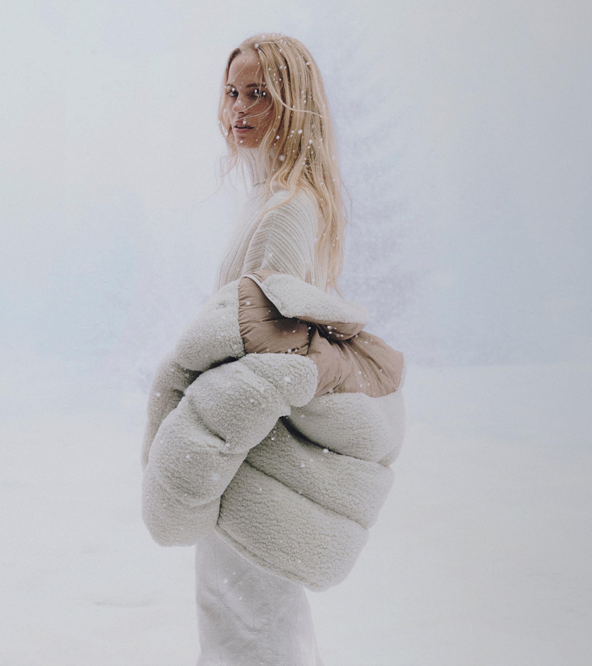 Models posing in sweaters and outerwear