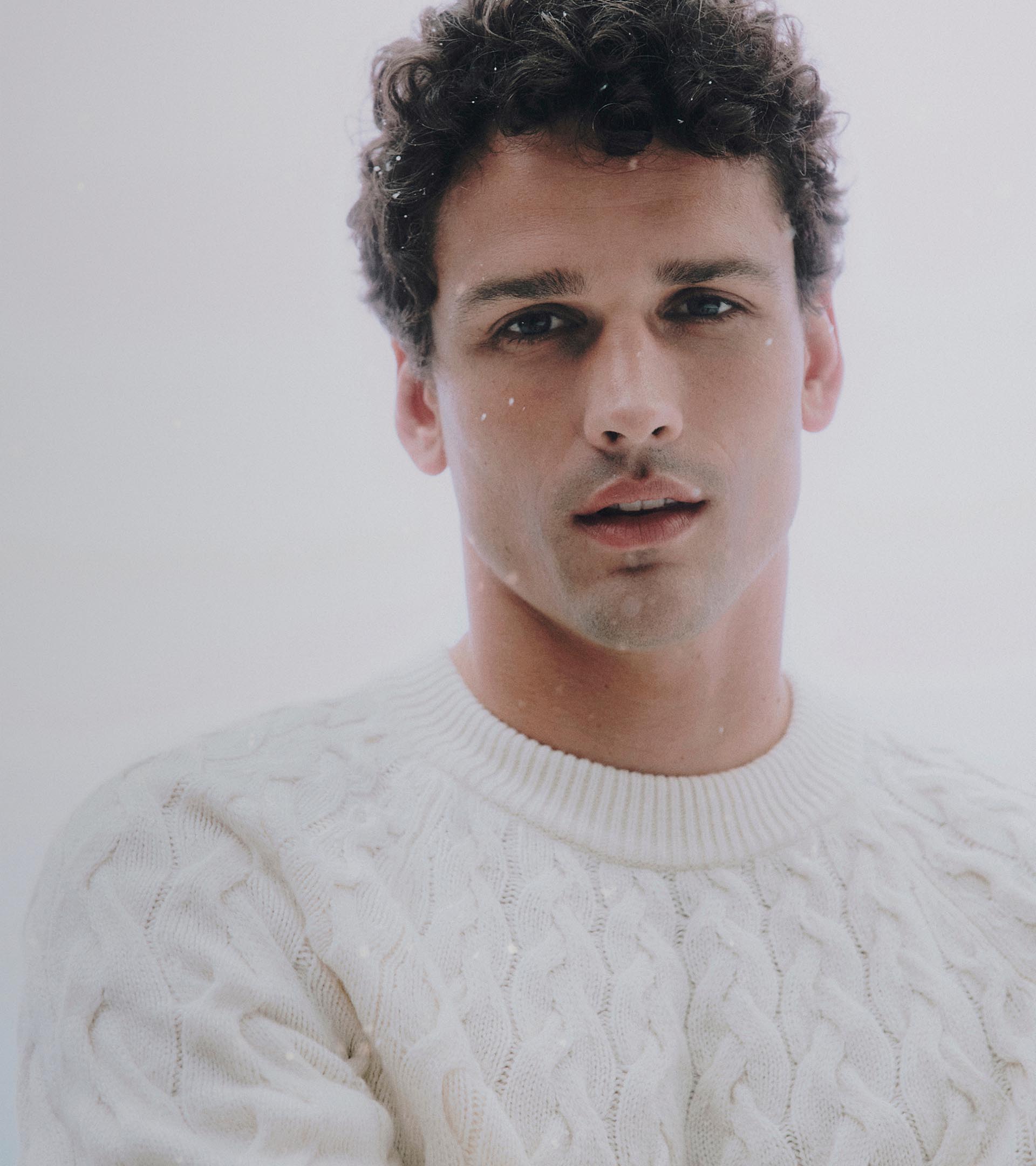 Models posing in sweaters and outerwear