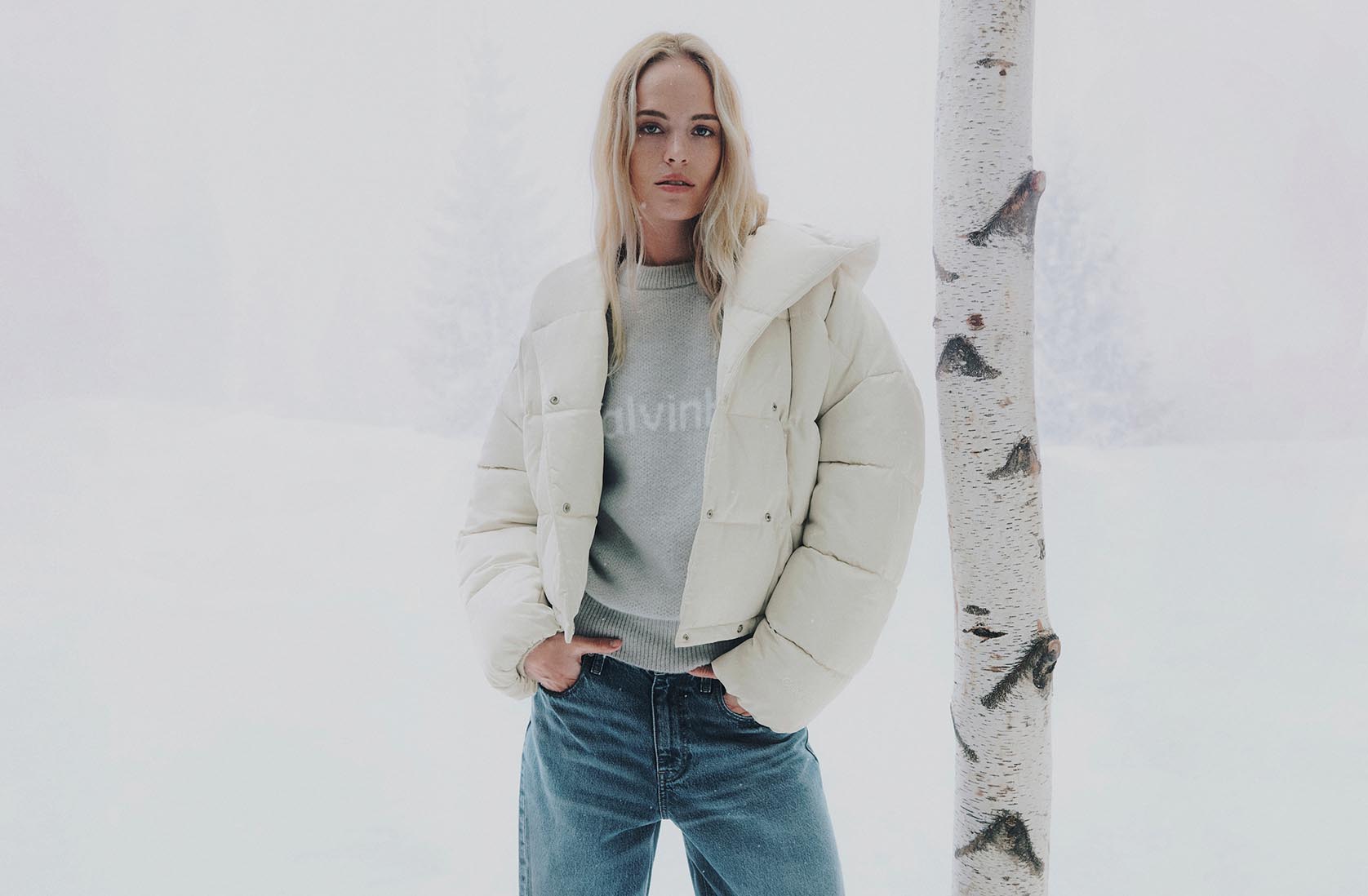 Model in white puffer and jeans