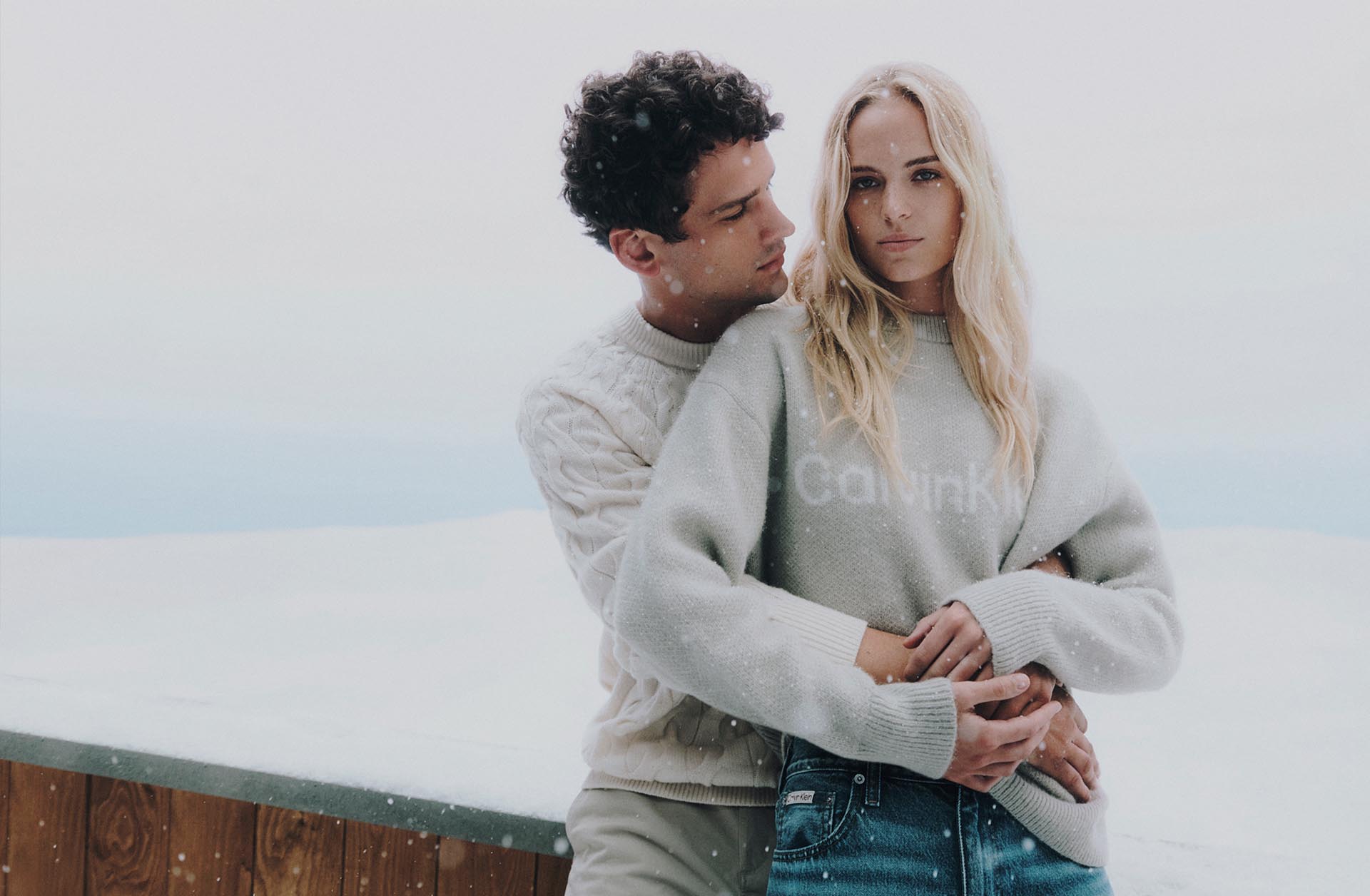 Models posing in cozy Calvin Klein sweaters 