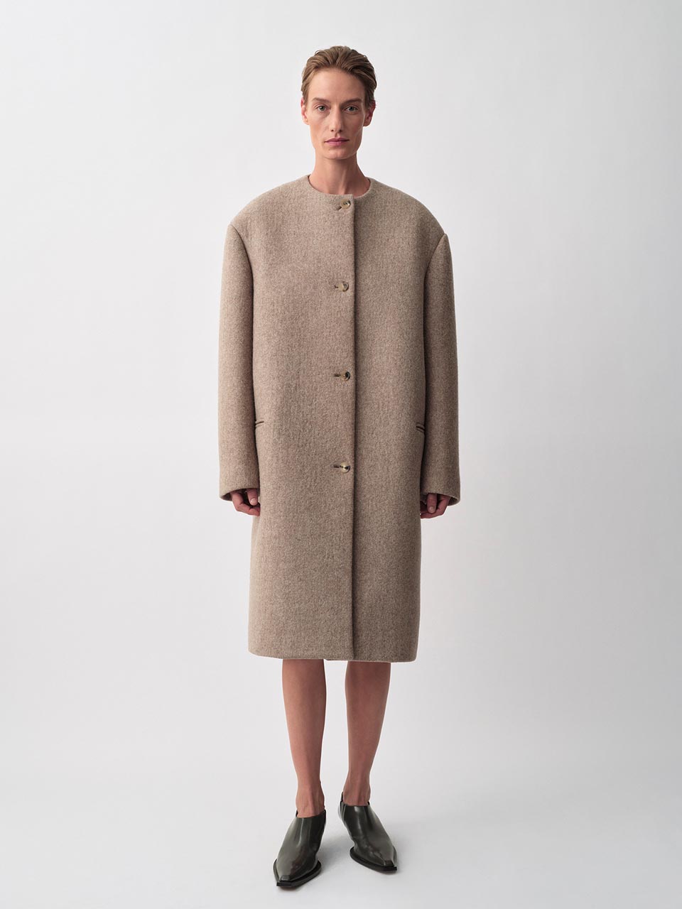 Model posing in a Calvin Klein Collection coat