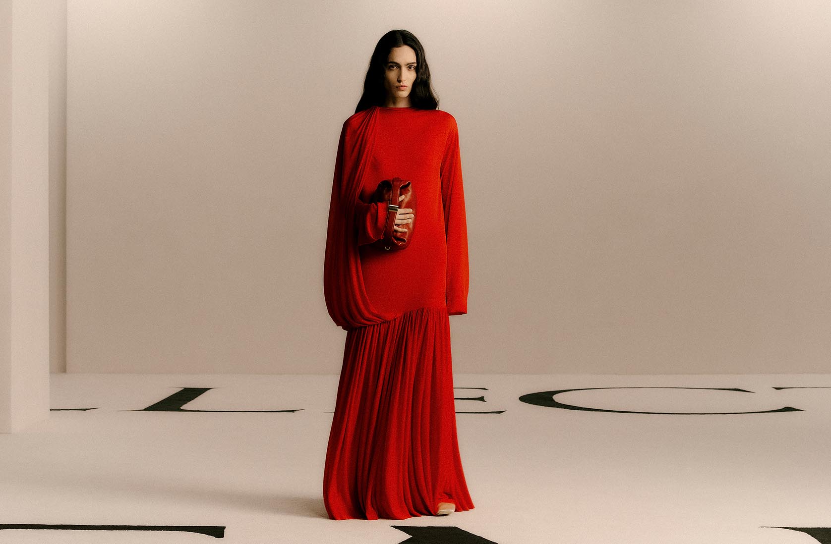 Model wearing a red Calvin Klein Collection evening dress