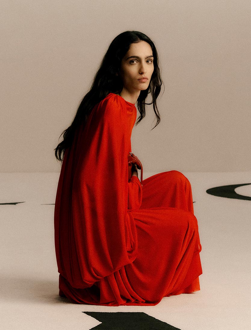 Model wearing a red Calvin Klein Collection evening dress