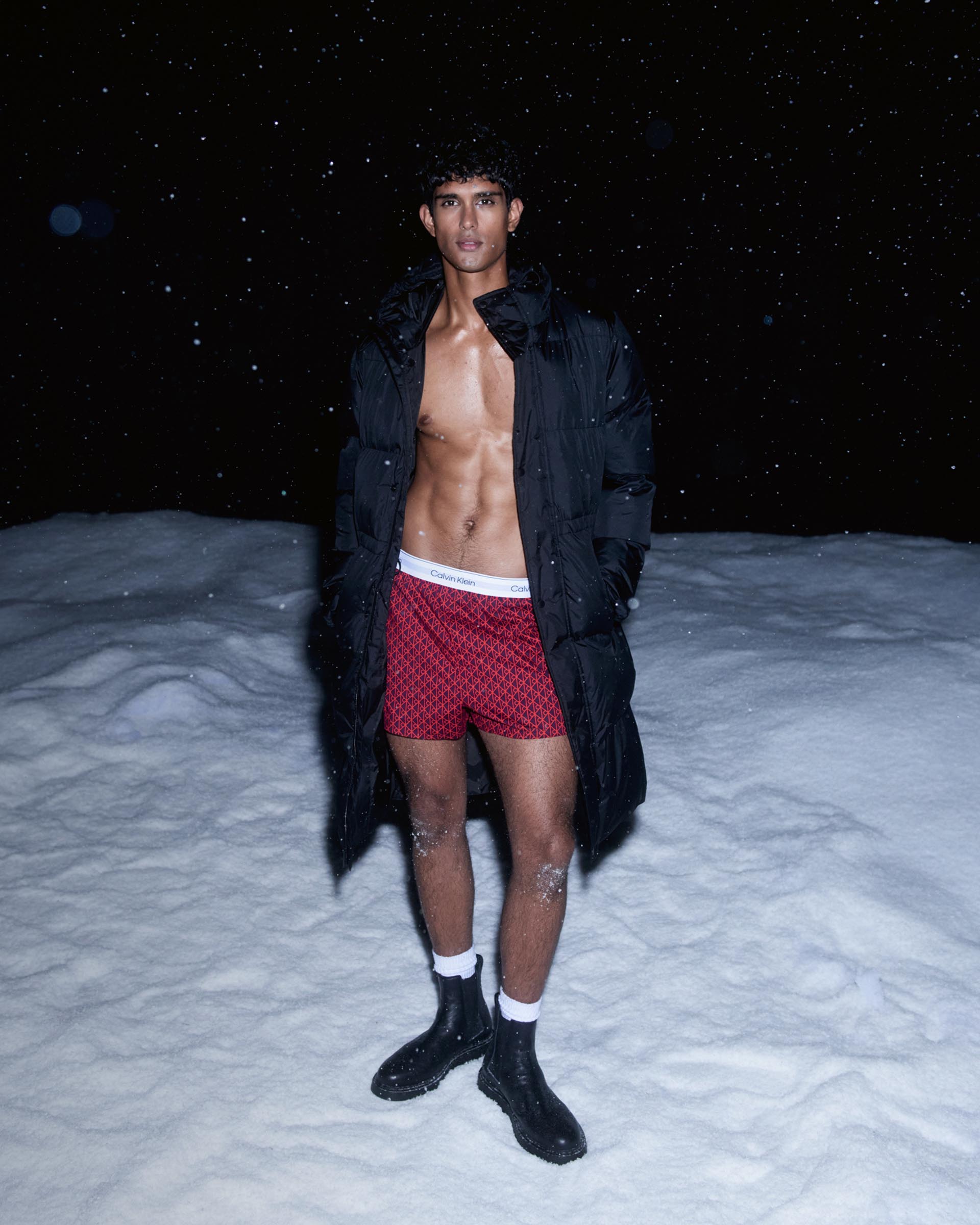 Models posing in Calvin Klein puffer coats