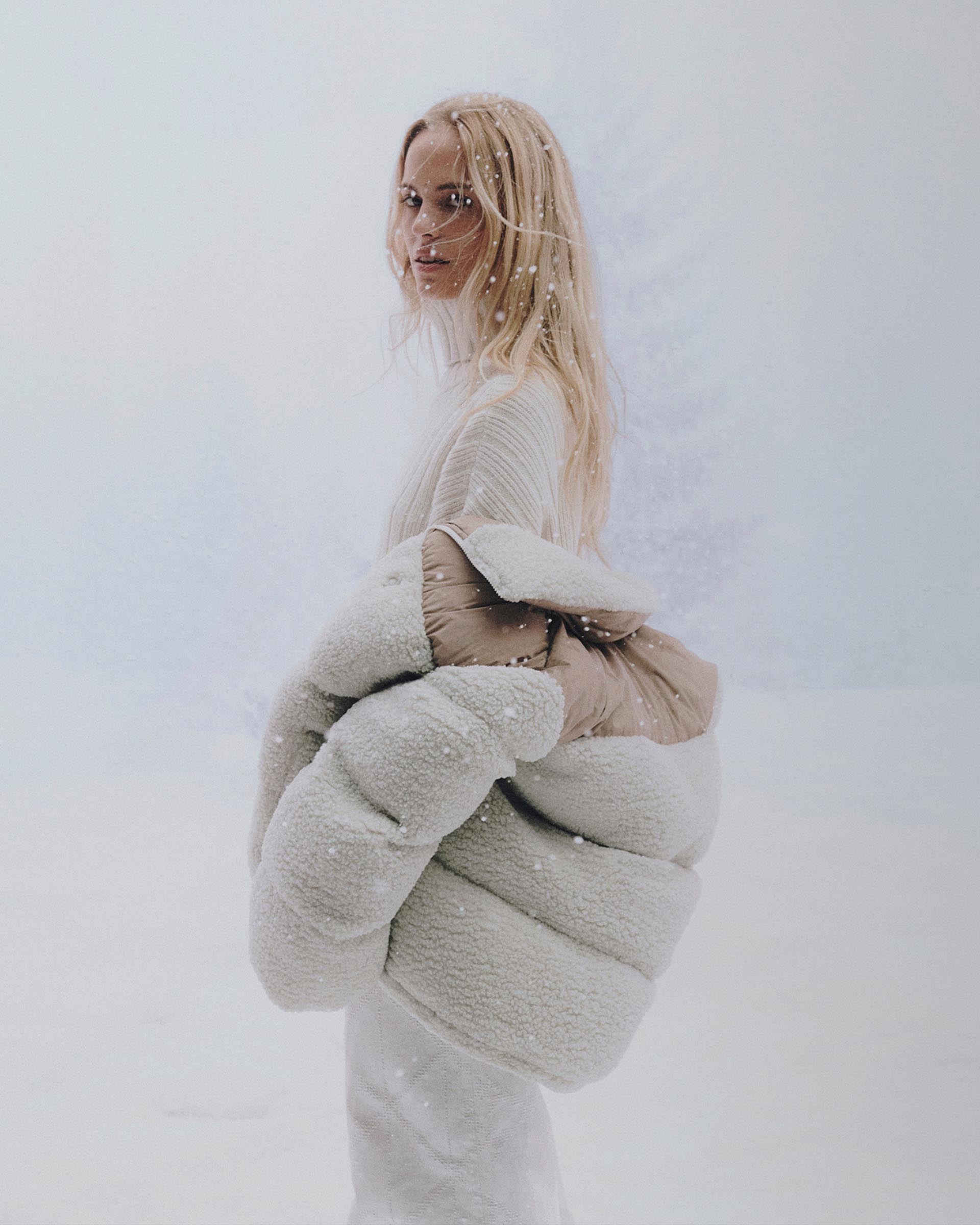 Models posing in Calvin Klein puffer coats