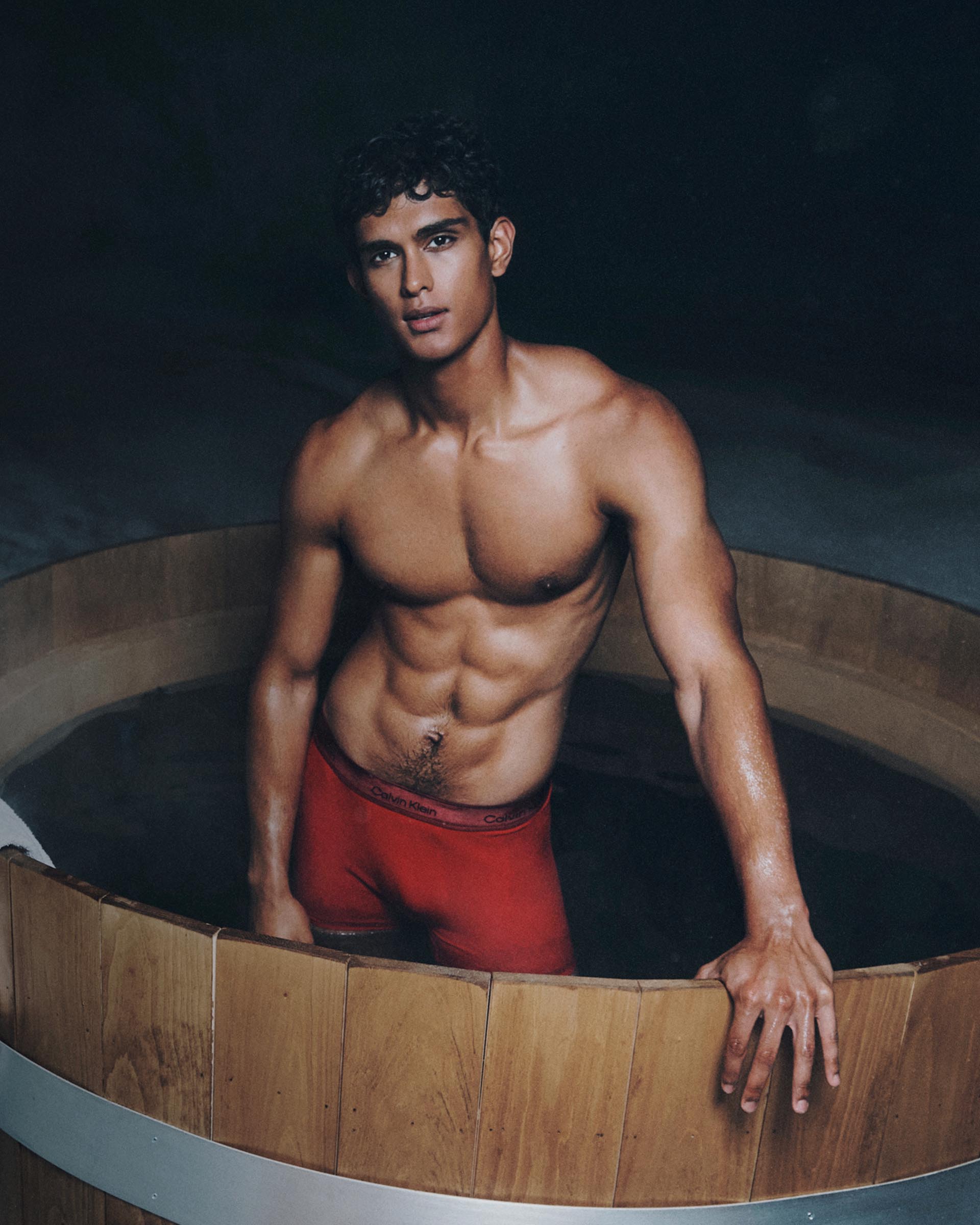Models posing in red Calvin Klein underwear