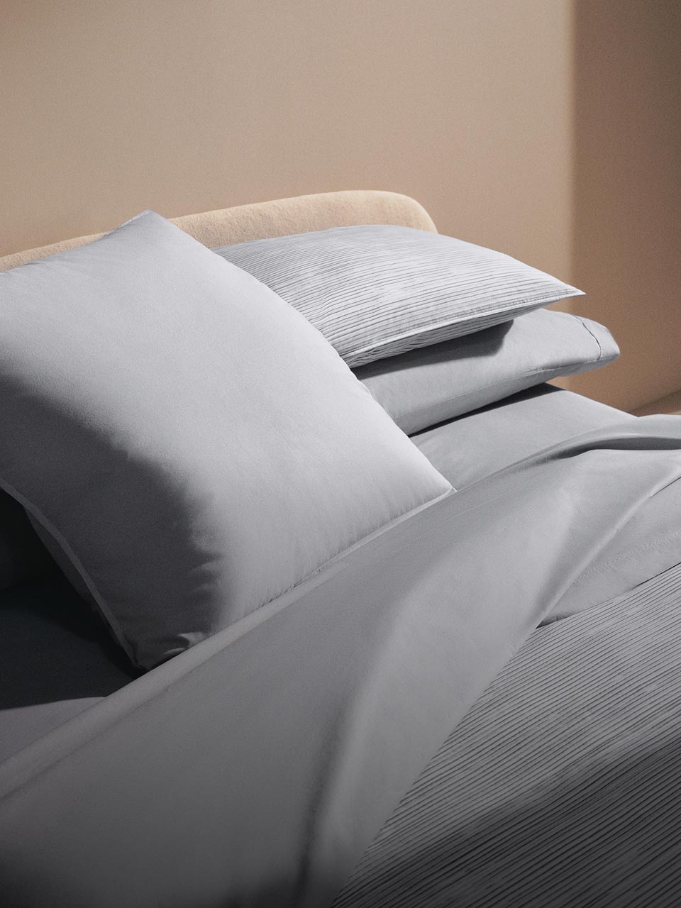 Still life image of a bed with green sheets and comforter