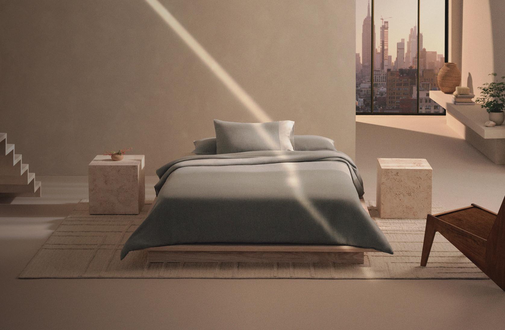 Still life image of a bed with grey bedding