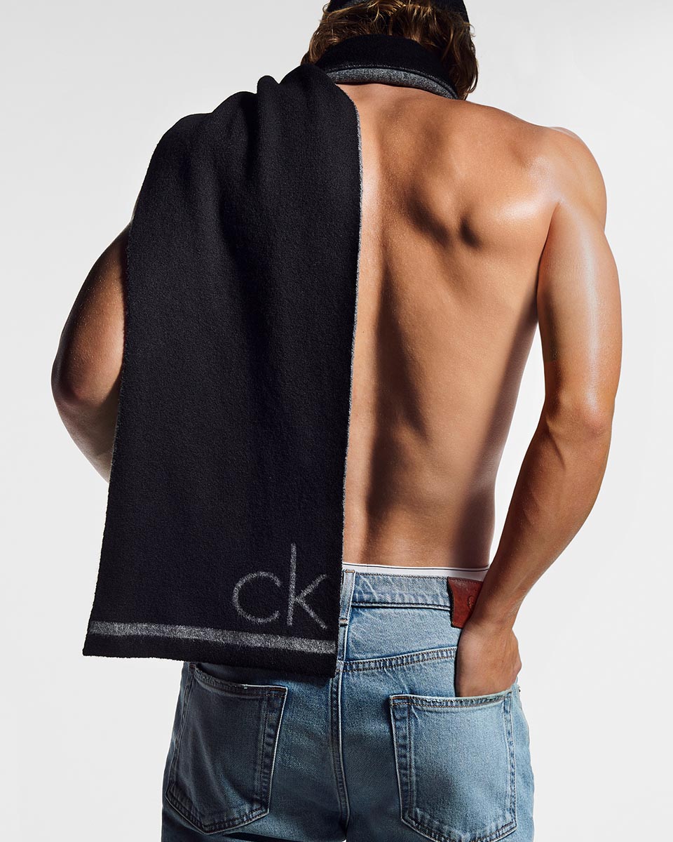A model posing in a CK logo scarf