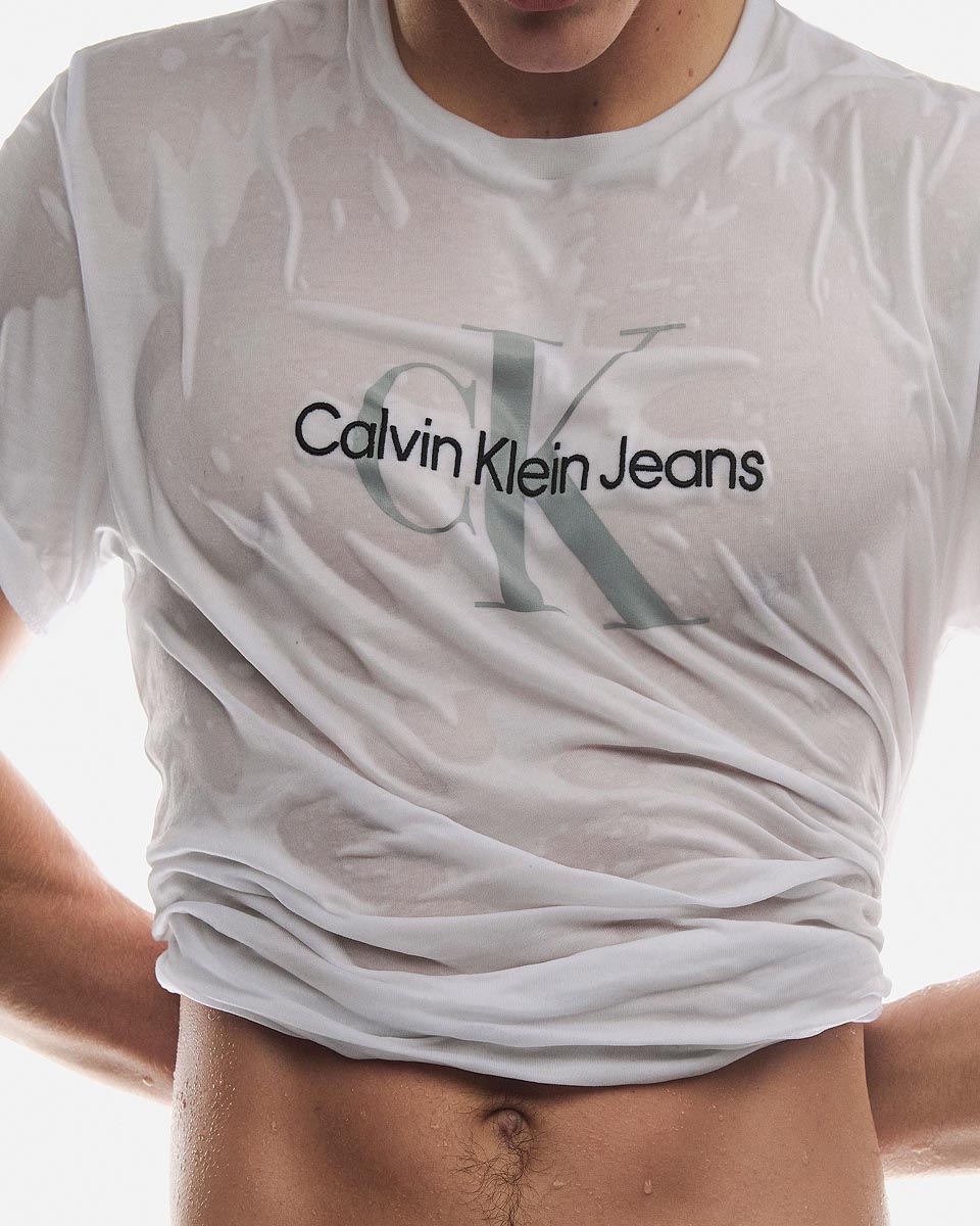 A model posing in a white CK logo t-shirt