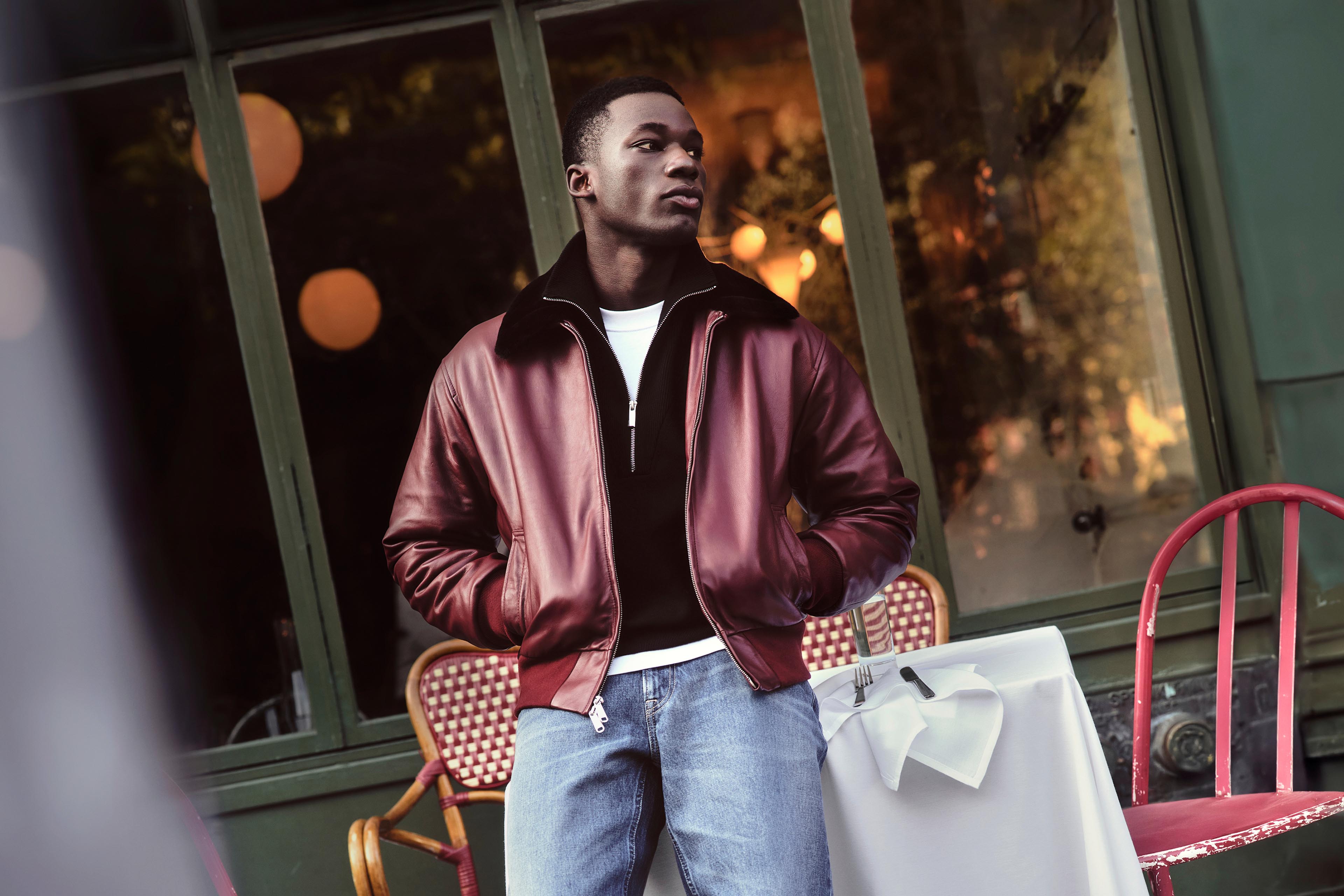 Model posing in a Calvin Klein leather jacket