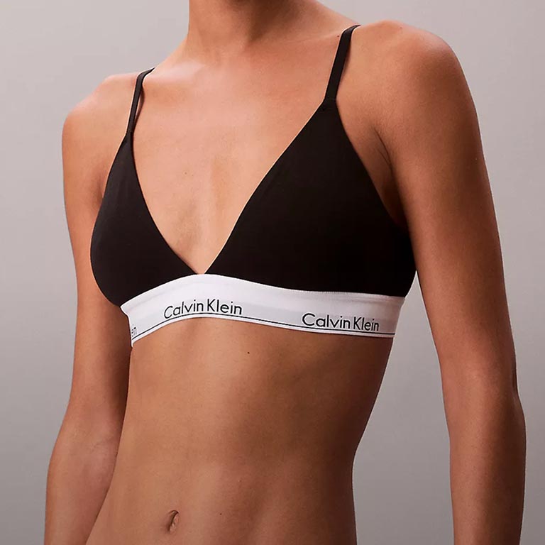 Model posing in a black triangle bralette